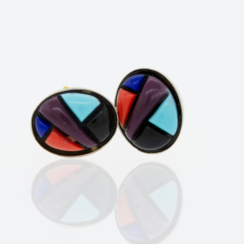 A pair of Super Silver American Made Multi-Stone Oval Shape Stud Earrings on a white surface.