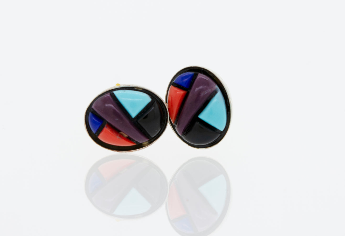 A pair of Super Silver American Made Multi-Stone Oval Shape Stud Earrings on a white surface.