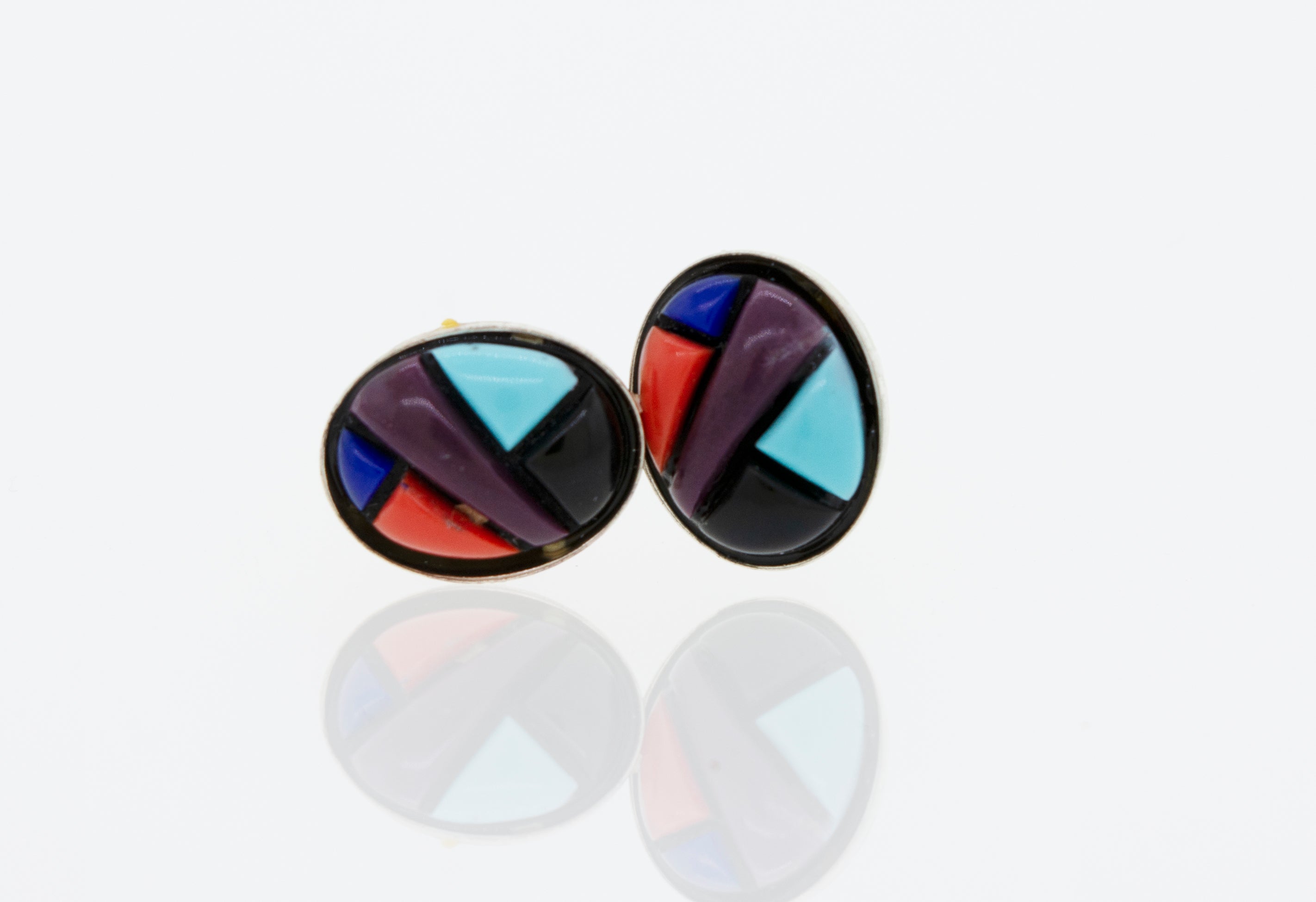 A pair of Super Silver American Made Multi-Stone Oval Shape Stud Earrings on a white surface.