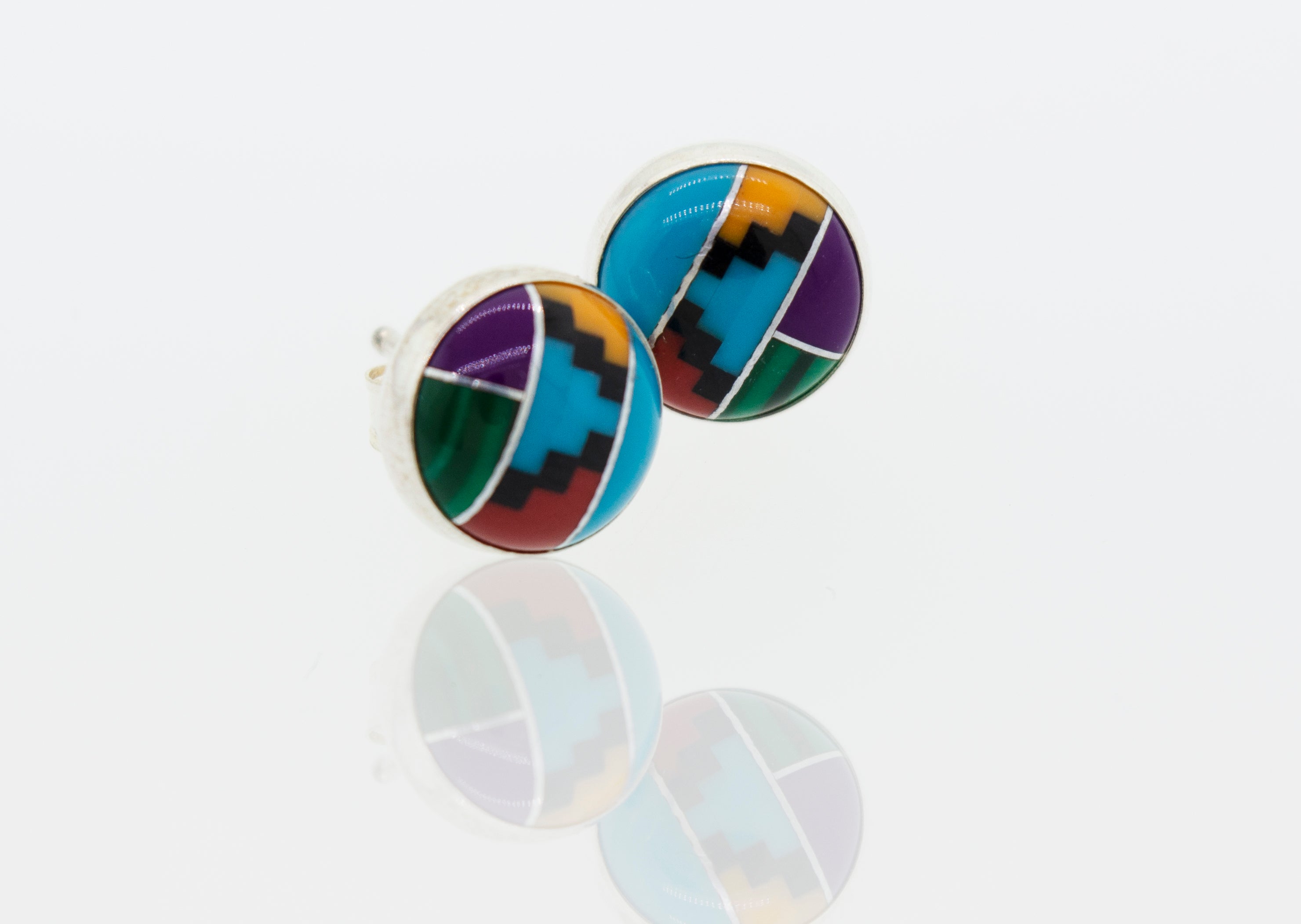 A pair of Super Silver American Made Multi-Stone Round Stud Earrings with a sterling silver frame on a white surface.