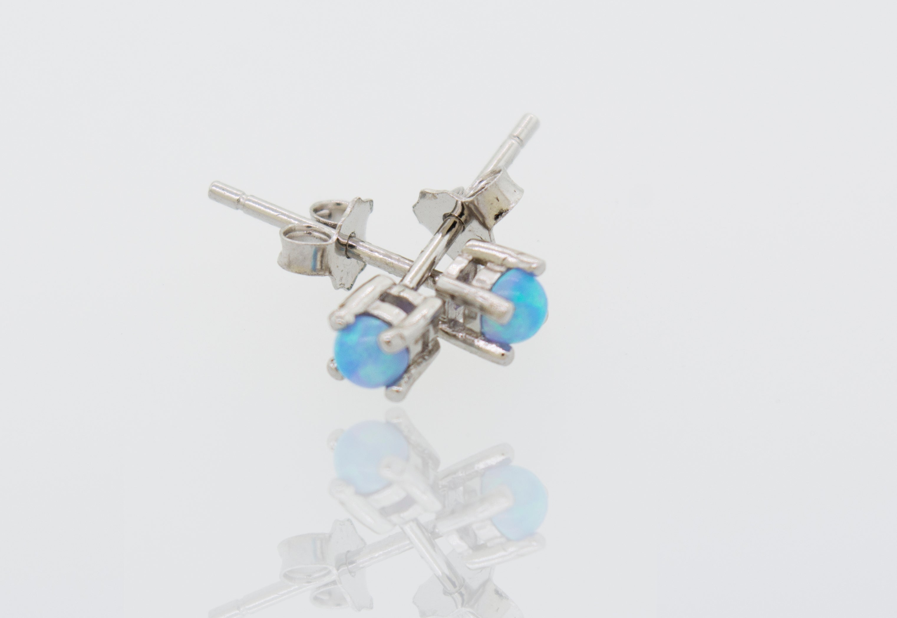 A pair of Super Silver Cultured Opal Stud Earrings featuring Lab-Created Opal on a white surface.
