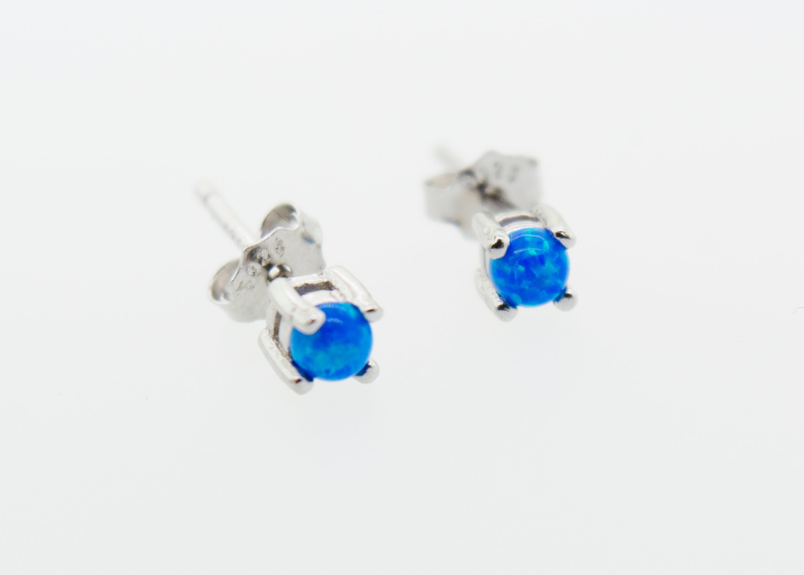 A pair of Super Silver Cultured Opal stud earrings on a white background.