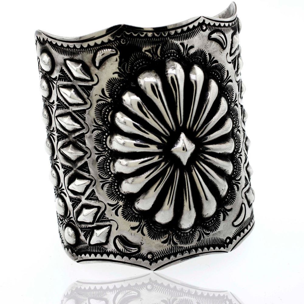 A Super Silver Hand Crafted Silver Concho Cuff bracelet with a southwest flower design.