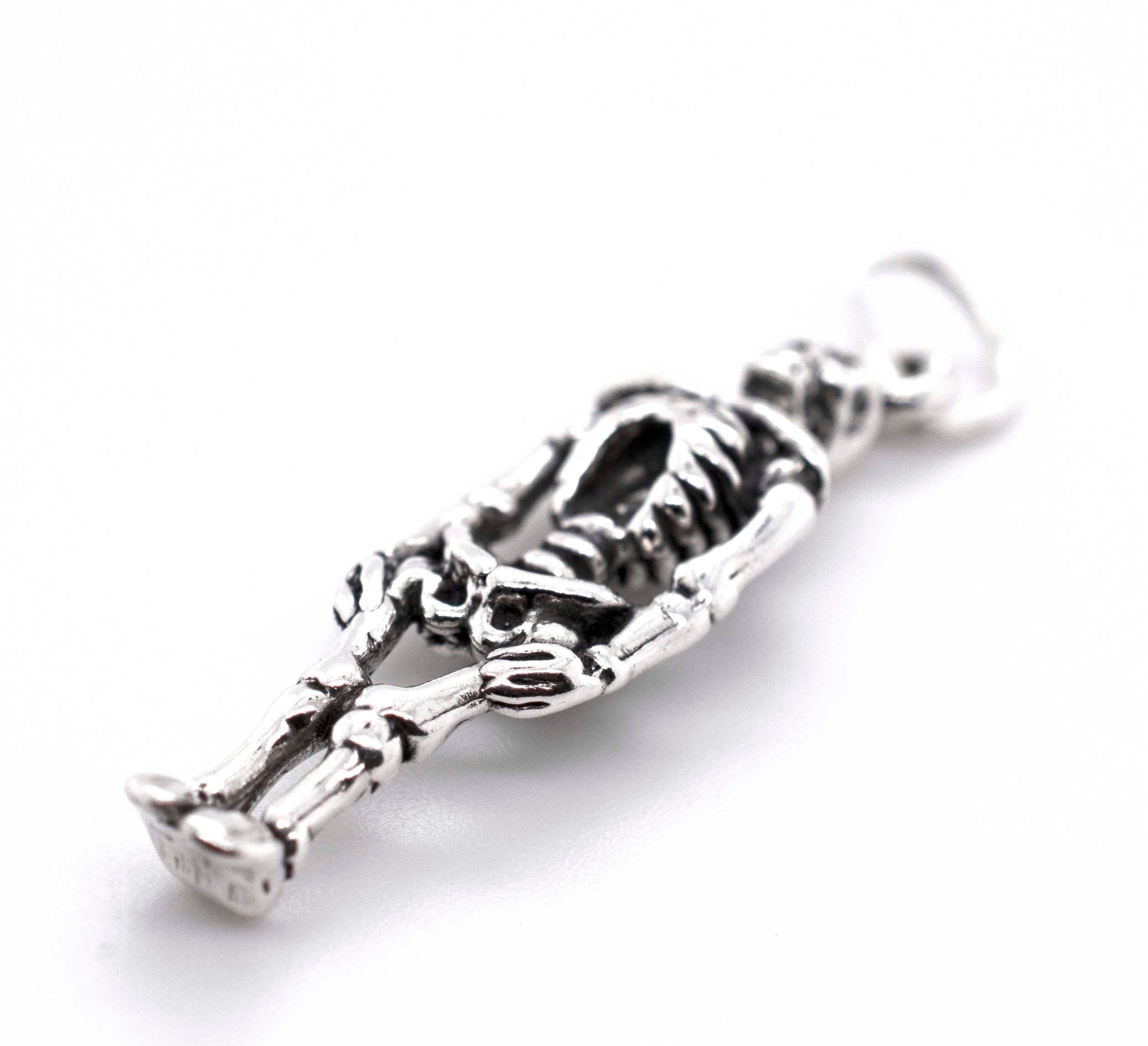 A Super Silver Small Skeleton Charm on a white background.