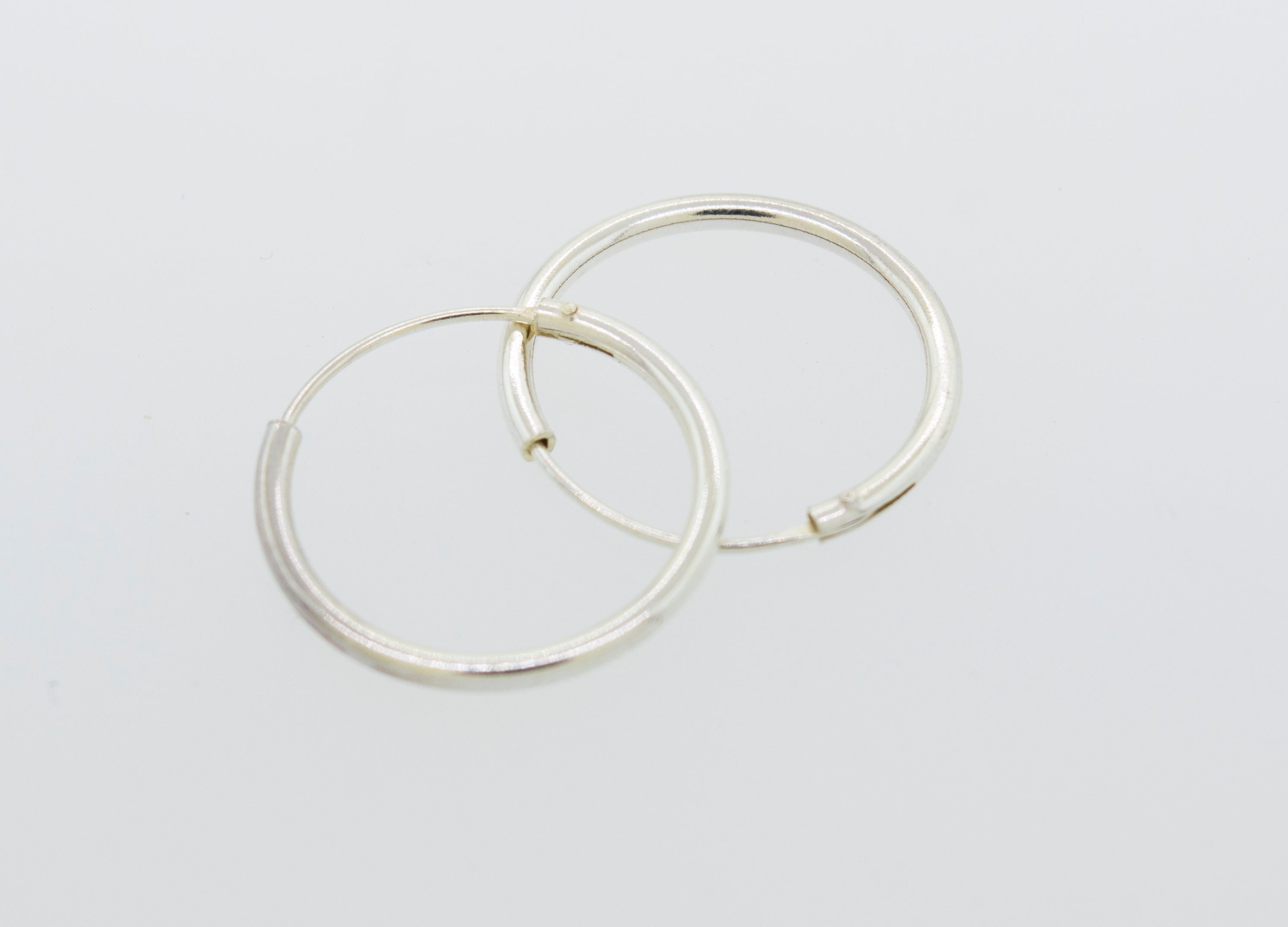 Everyday use Super Silver Silver Infinity Hoops 1mm X 17.5mm on a white surface.