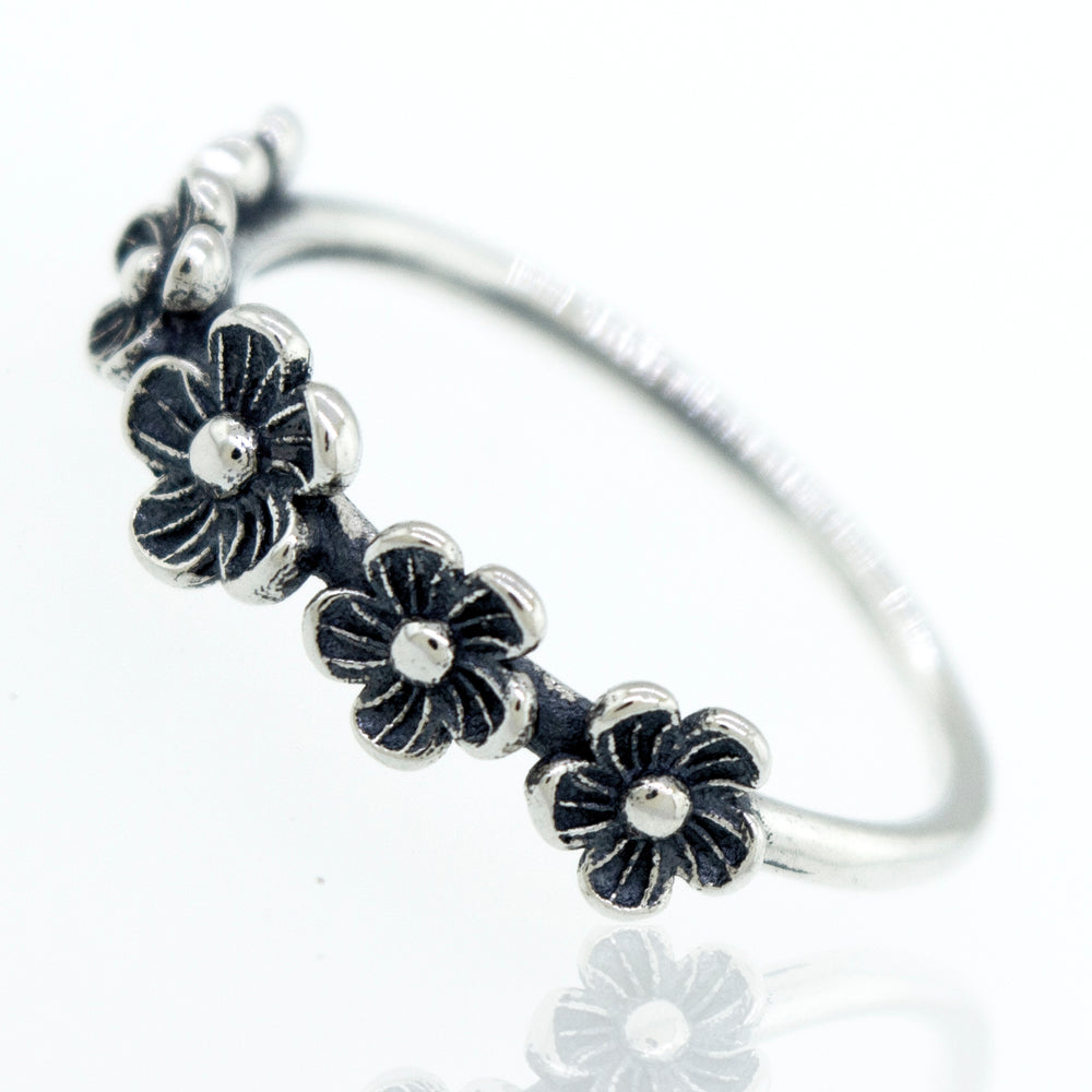 A boho silver Flower Band Ring with black stones.