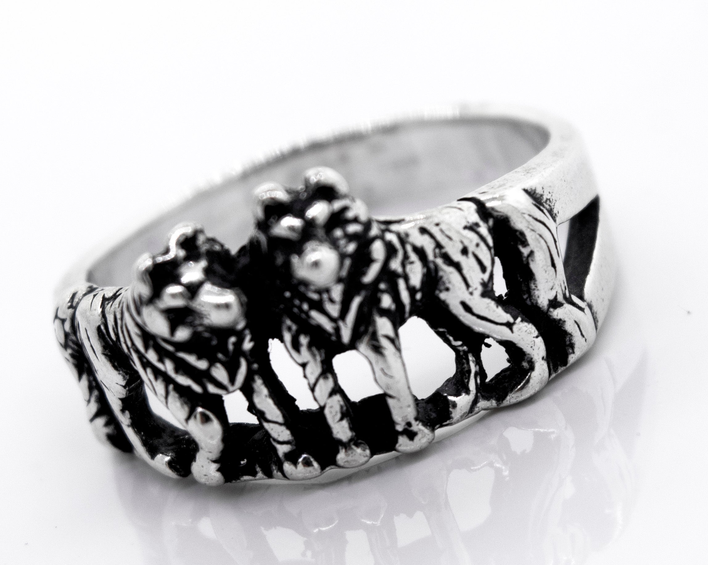 The Super Silver American Made Wolf Ring features three wolves elegantly engraved on it.