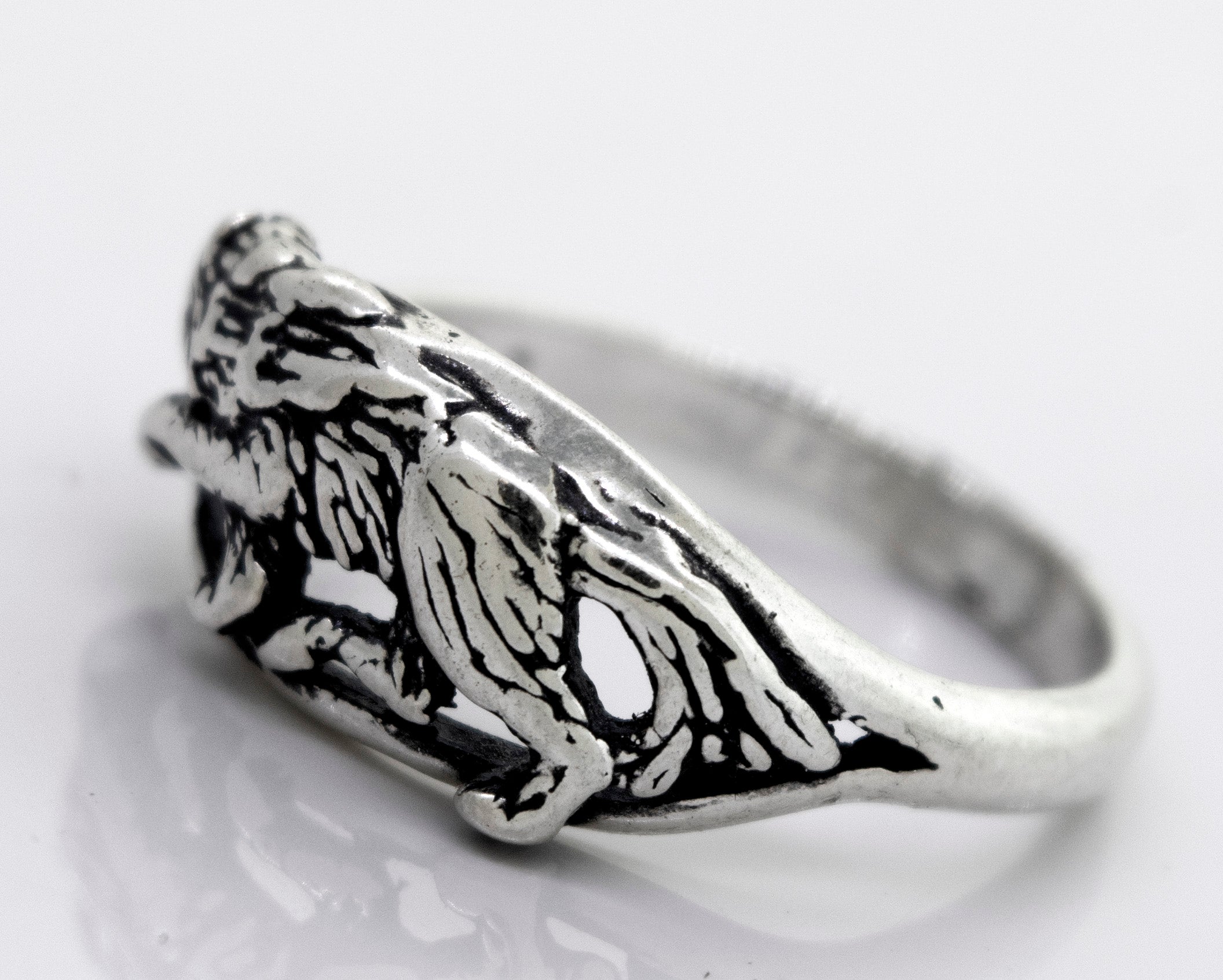 An American Made Prowling Wolf Ring from Super Silver with an image of a lion on it.