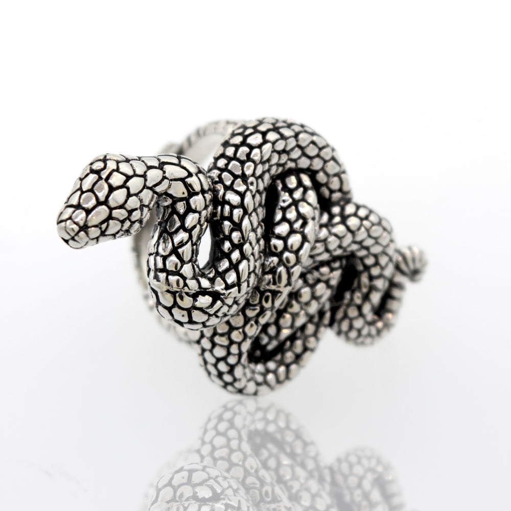 A Coiled Snake Ring with an adjustable band, slithering serpent design, on a white surface. Brand: Super Silver.