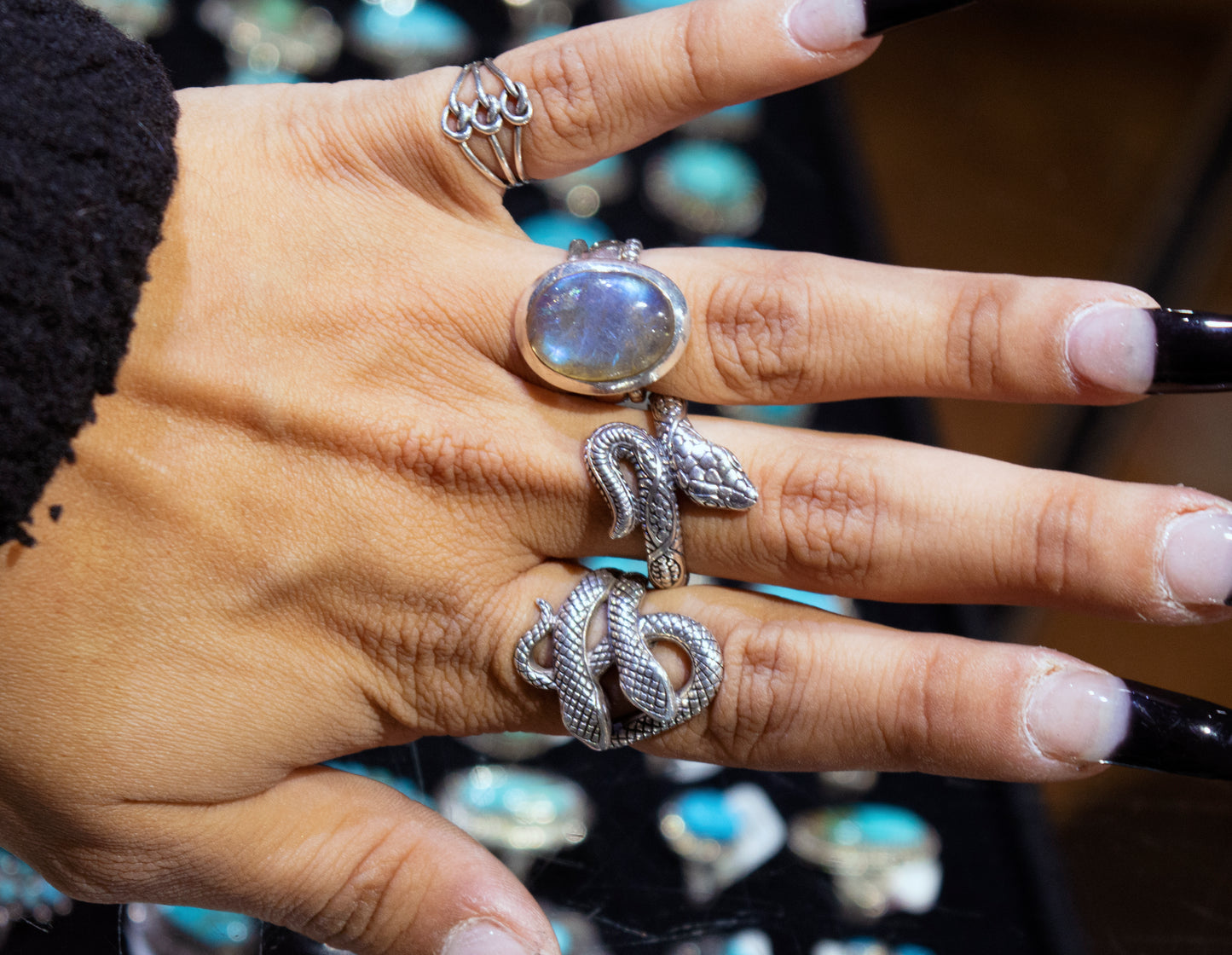 
                  
                    A handcrafted Super Silver Double Headed Snake Ring beautifully adorns a woman's hand.
                  
                