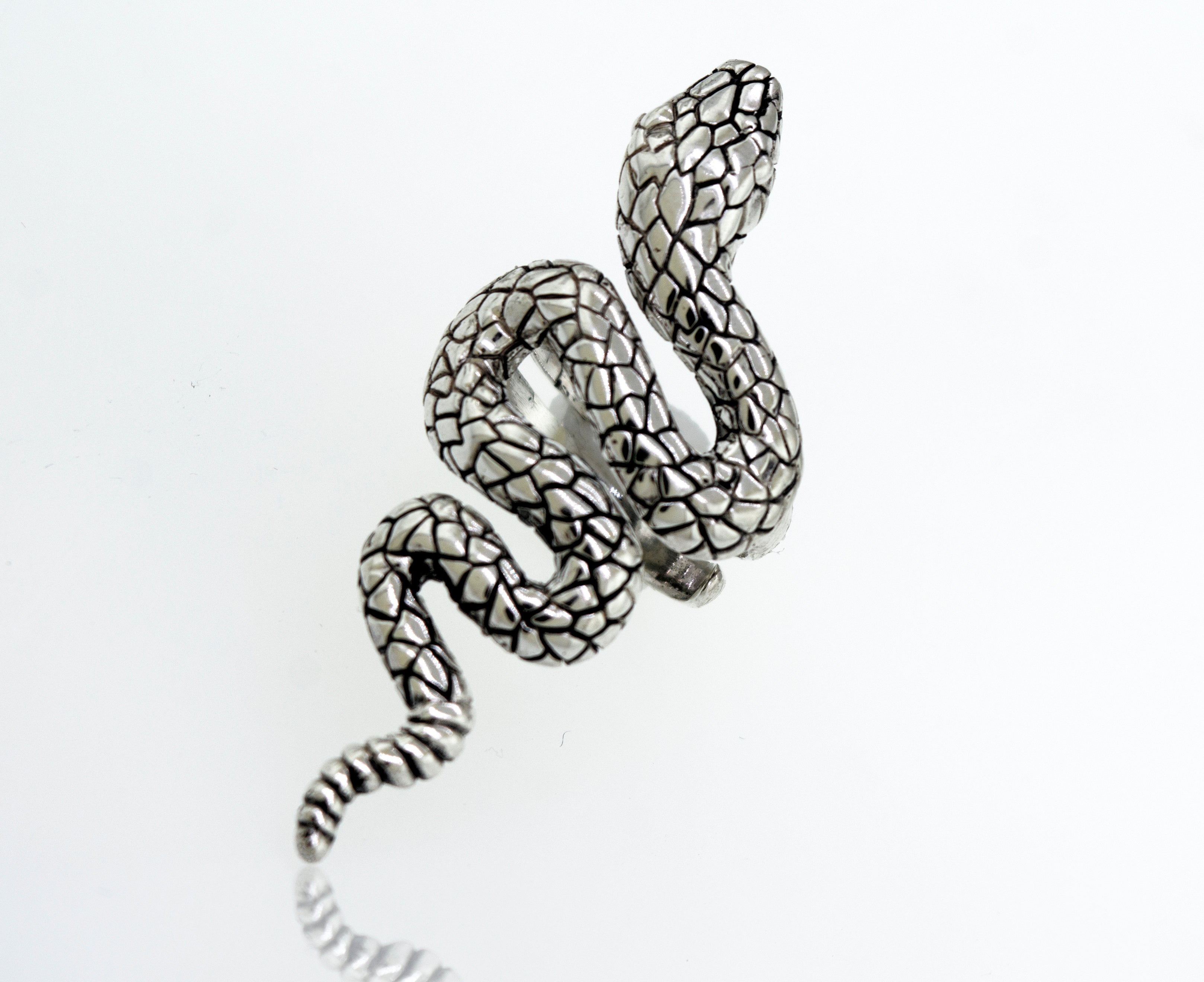 An adjustable Long Alluring Snake Ring crafted by an artisan, resting on a clean white surface.