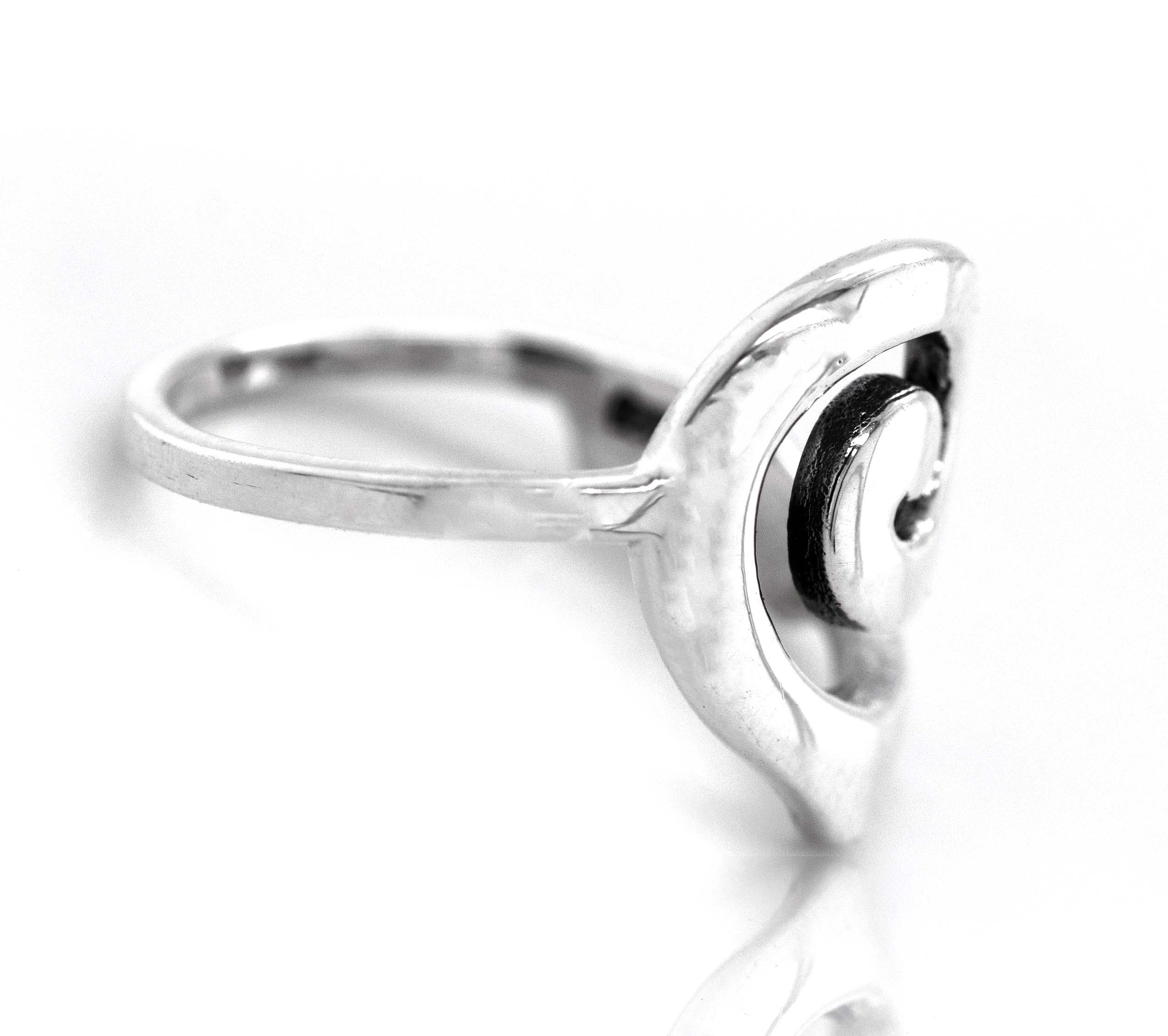 A sterling silver spiral design ring with an abstract heart shaped design.