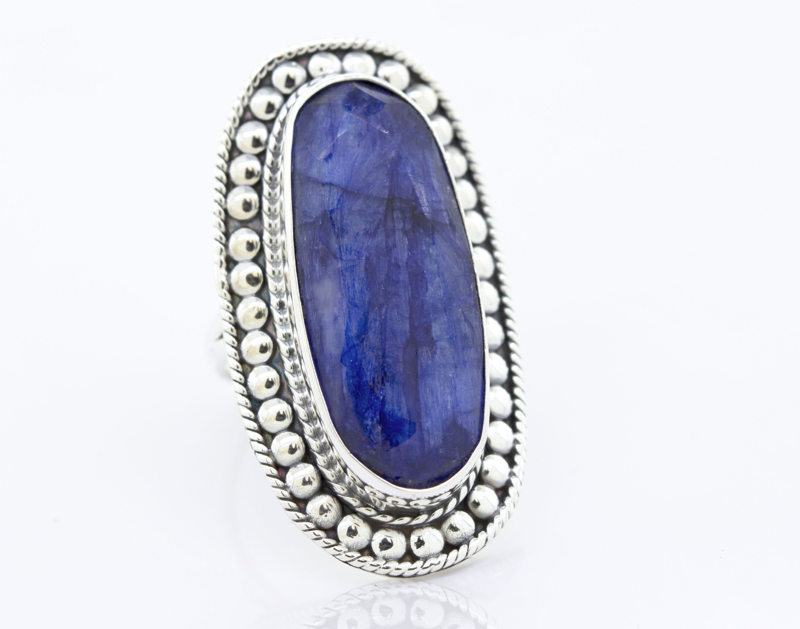 An Elegant Raw Blue Sapphire Ring by Super Silver with a lapis stone in a sturdy silver setting.