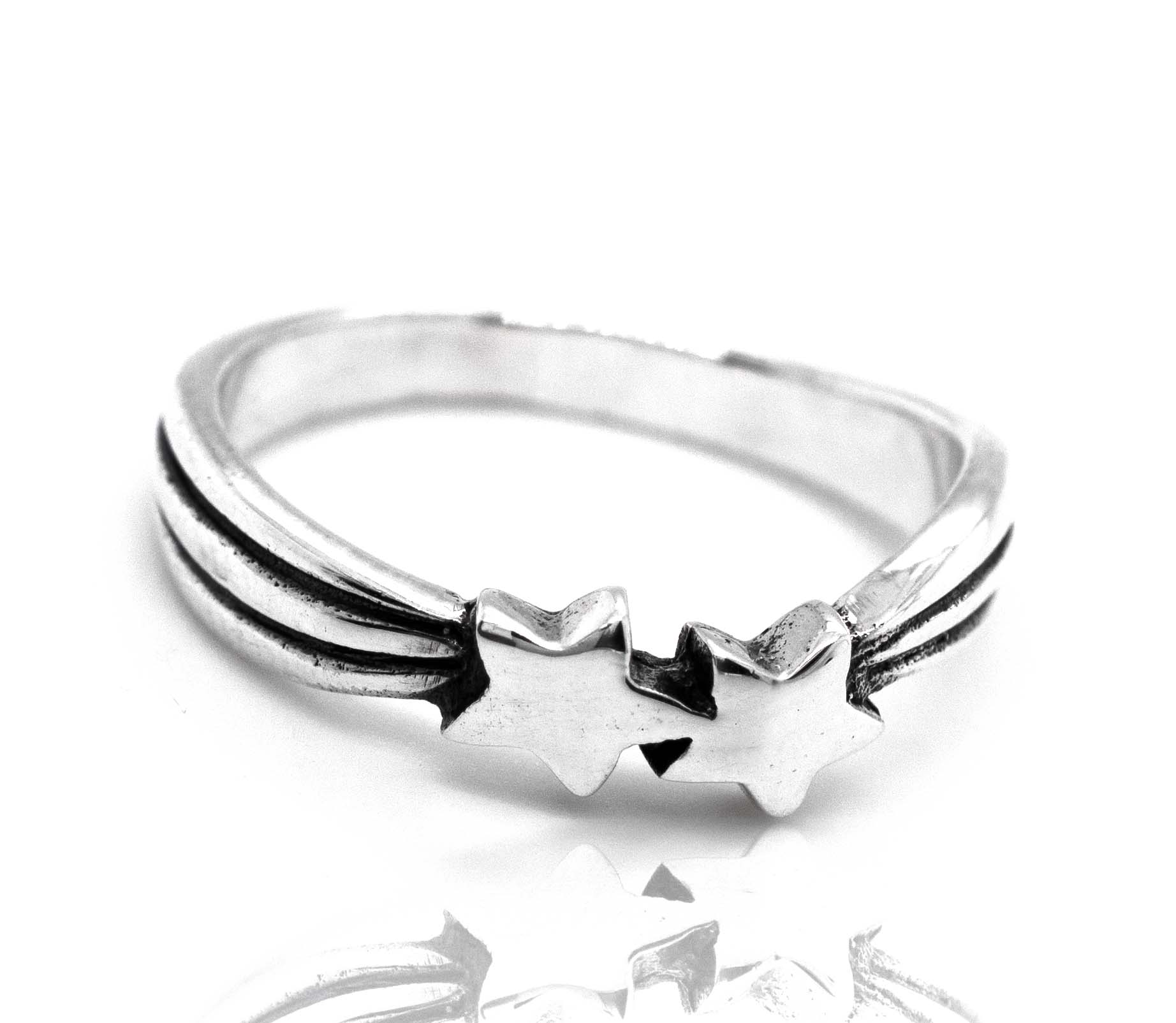 Double Shooting Star Ring with a sterling silver band, isolated on a reflective white surface.