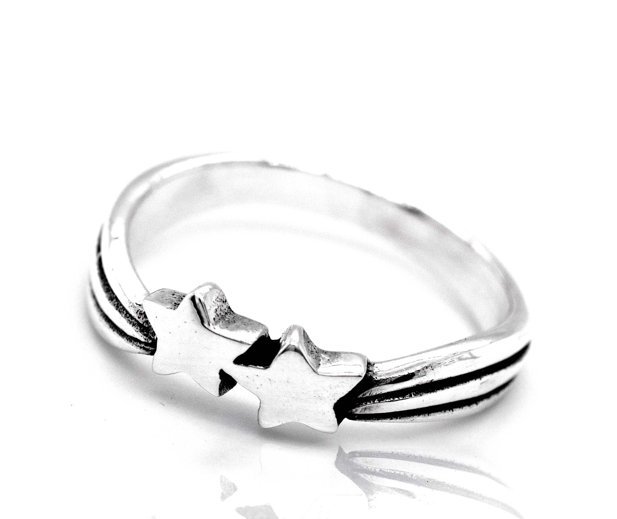 A sterling silver Double Shooting Star Ring featuring a simple band design with two interlocked shooting star shapes at the top, set against a white background.