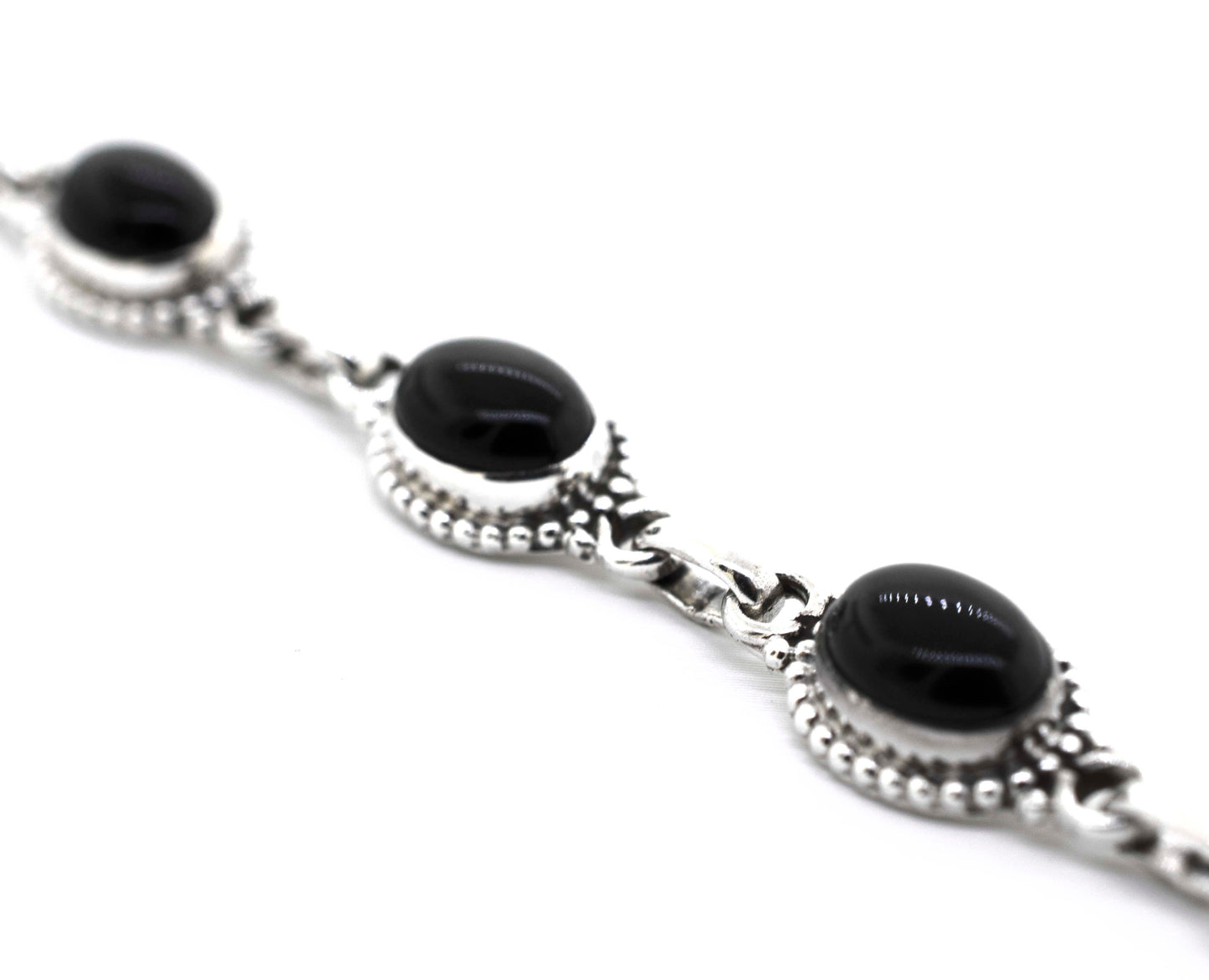
                  
                    A Super Silver Oval Gemstone Bracelet With Ball Border with black onyx stones.
                  
                