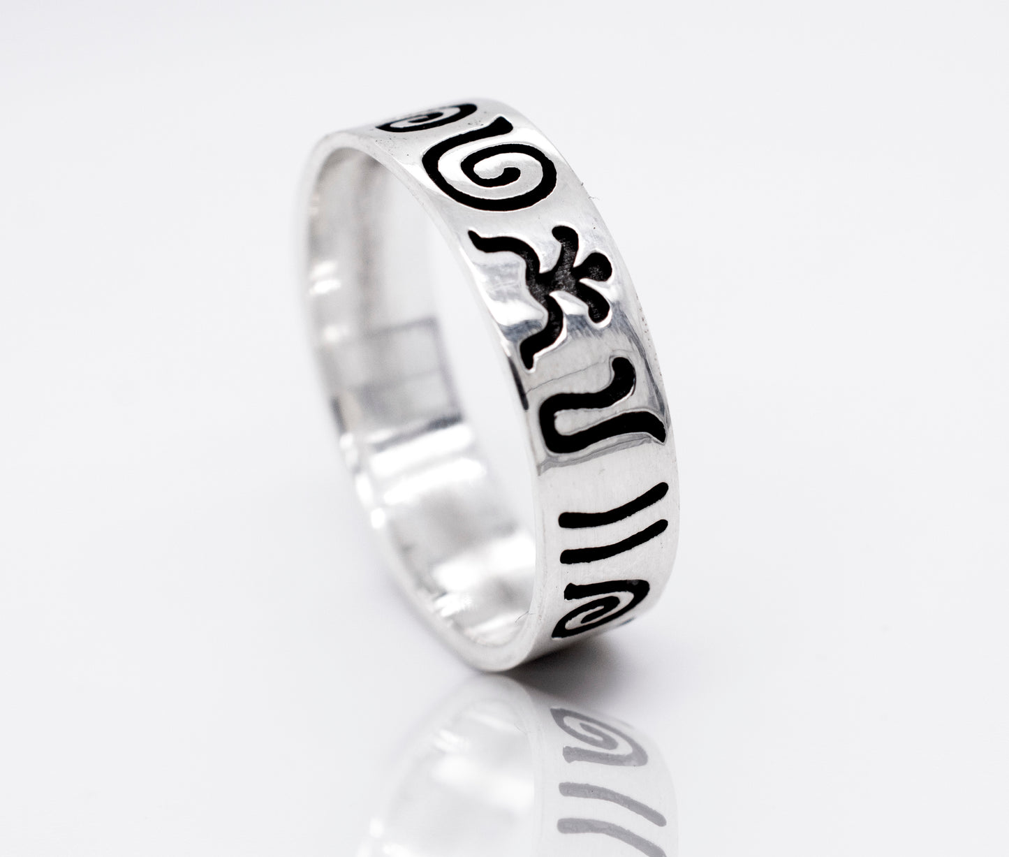 A Super Silver Aztec Symbols Band with a black and white design featuring carved Aztec symbols, giving it an oxidized look.