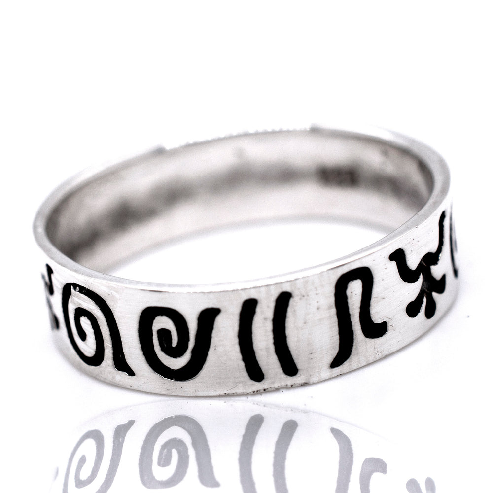 A Super Silver Aztec Symbols Band with black writing on it.