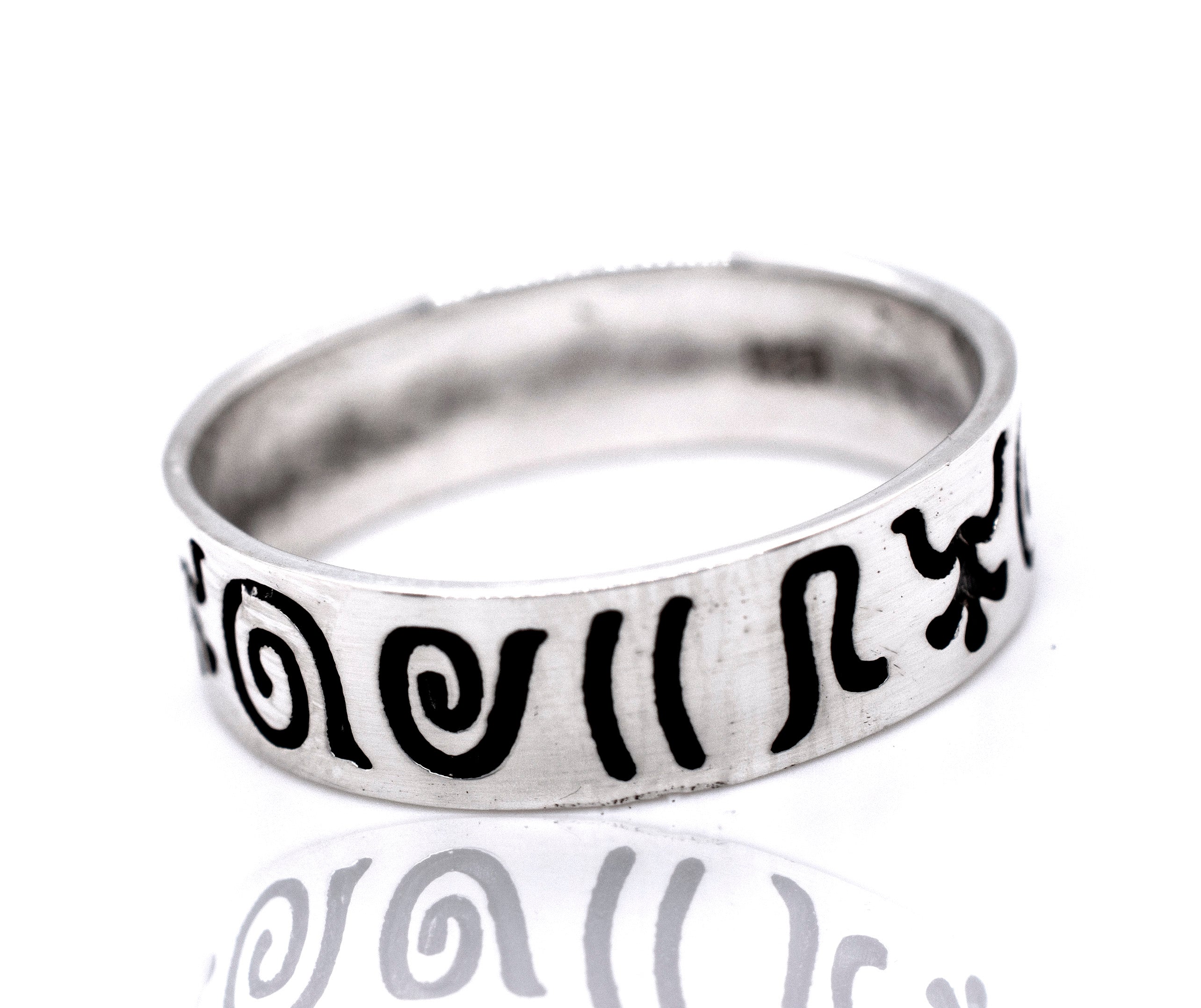 A Super Silver Aztec Symbols Band with black writing on it.