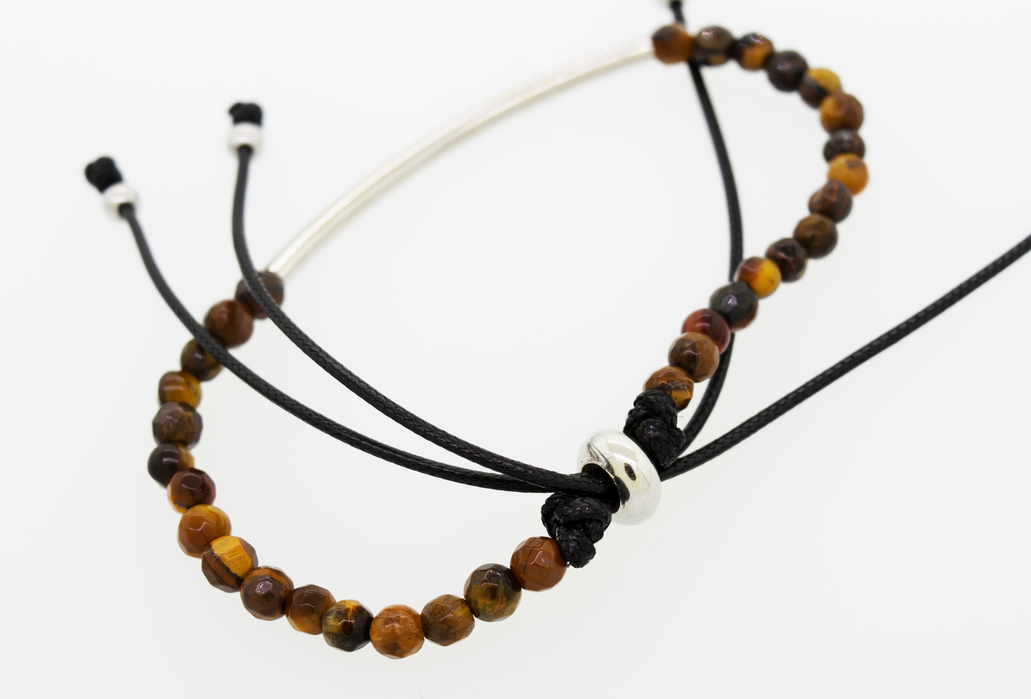 A Super Silver adjustable gemstone bead bracelet with a silver bar on a black cord.