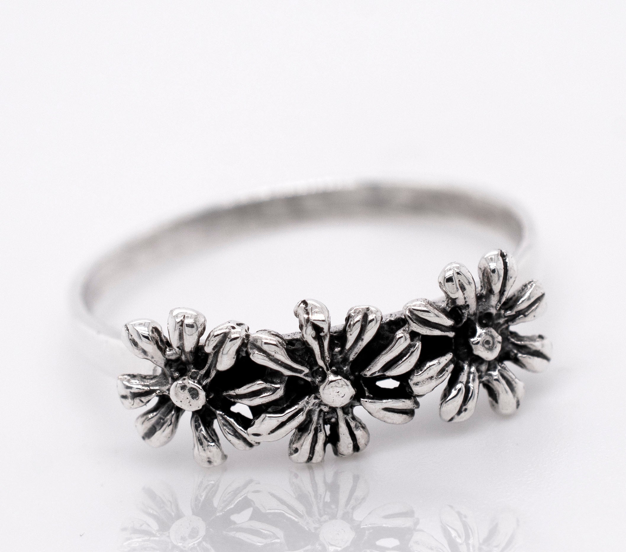Floral-inspired dainty three flowers design ring in sterling silver.