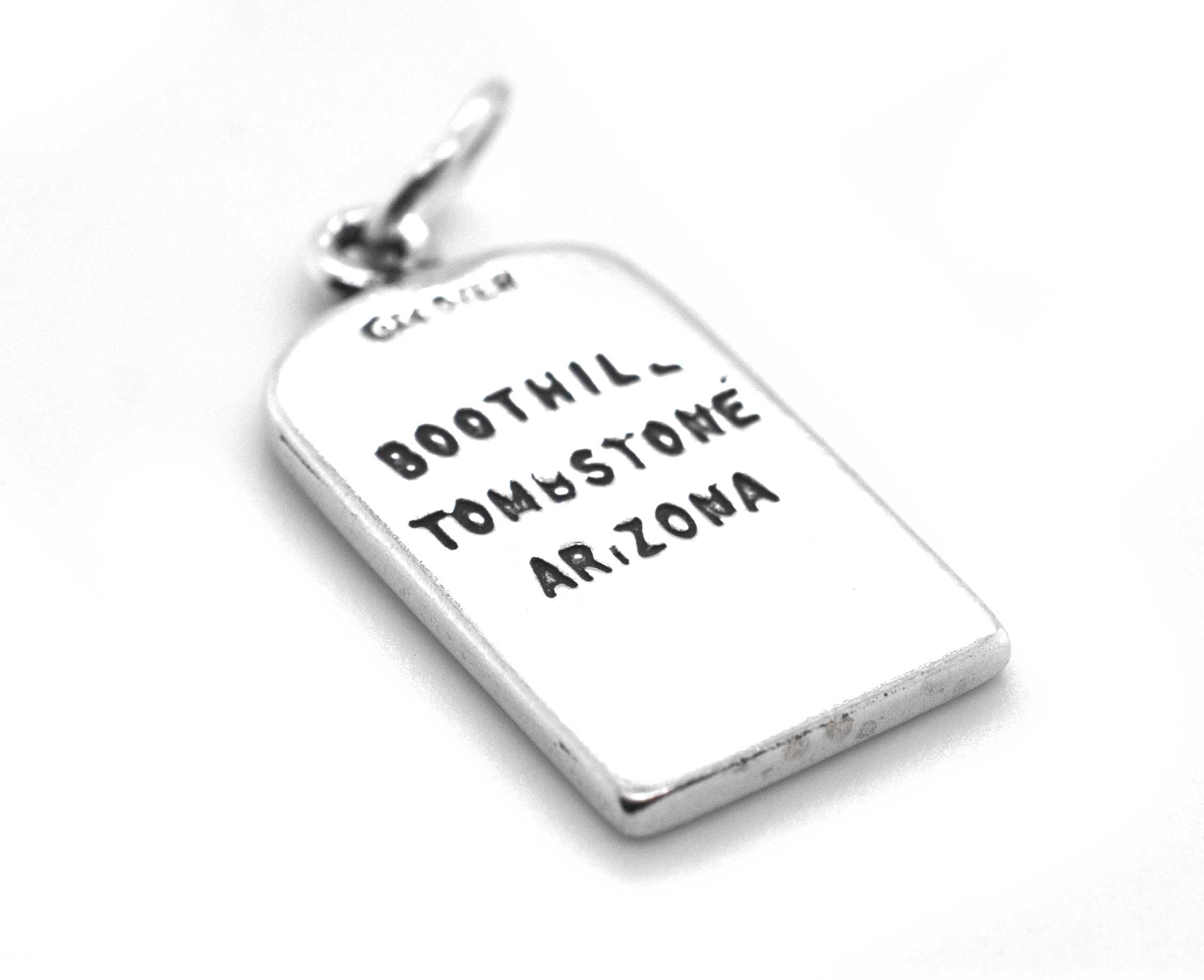 A Lester Moore Gravestone Charm pendant, inscribed with the words "Boot Hill Tontoe Arizona," by Super Silver.