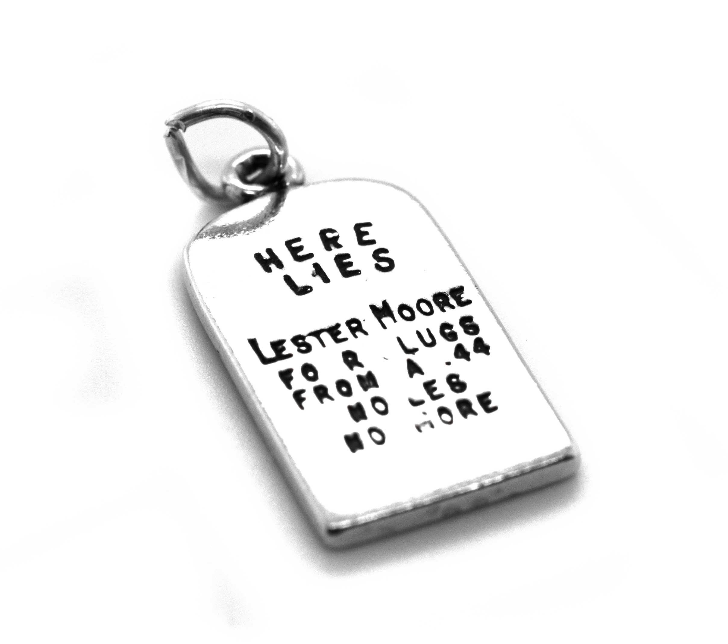 A Super Silver Lester Moore Gravestone Charm with the words 'here lies' on it, inspired by the Wild West era.