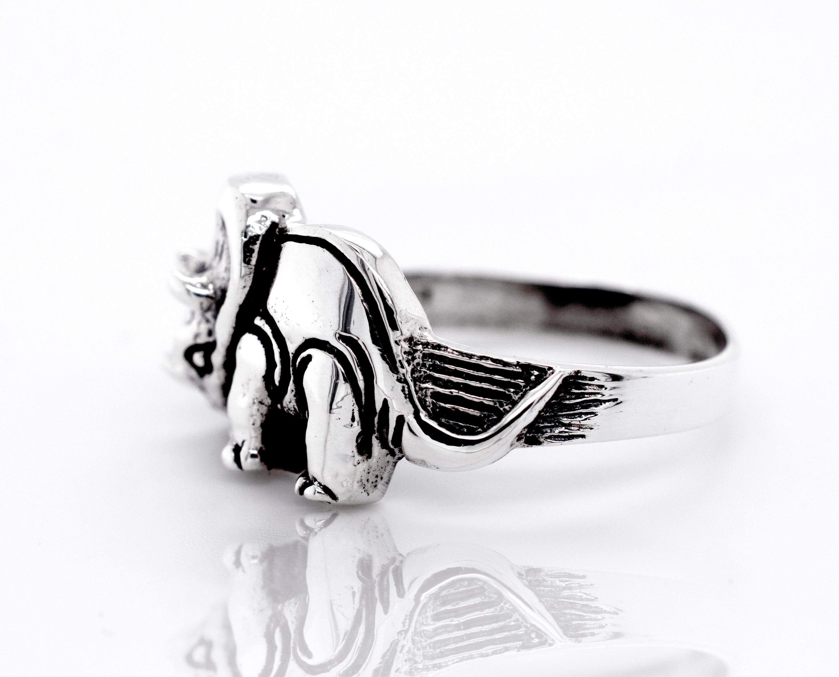 A Triceratops Ring by Super Silver with a teddy bear design on a wide silver band.