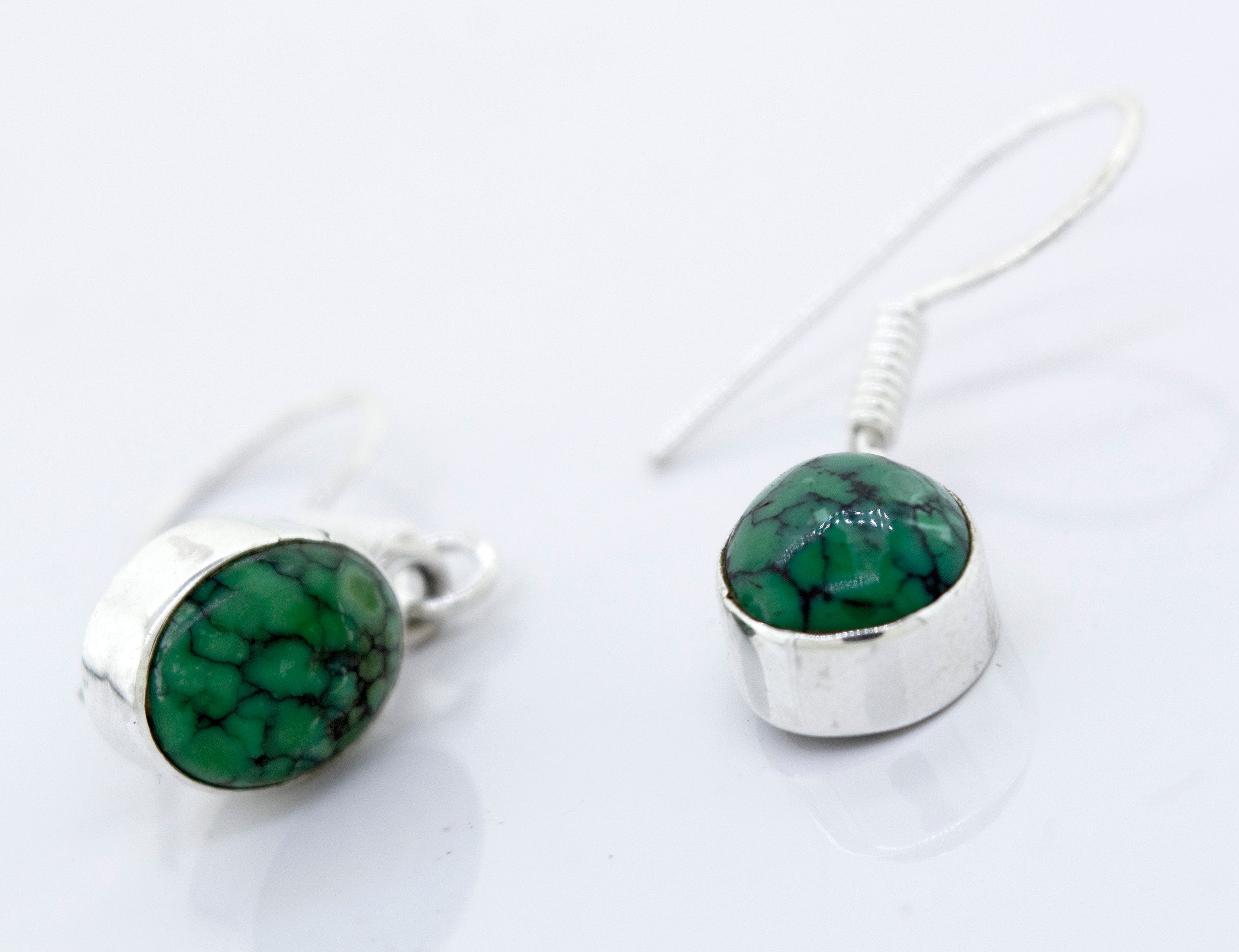 A pair of Super Silver Oval Natural Turquoise Dangle Earrings.