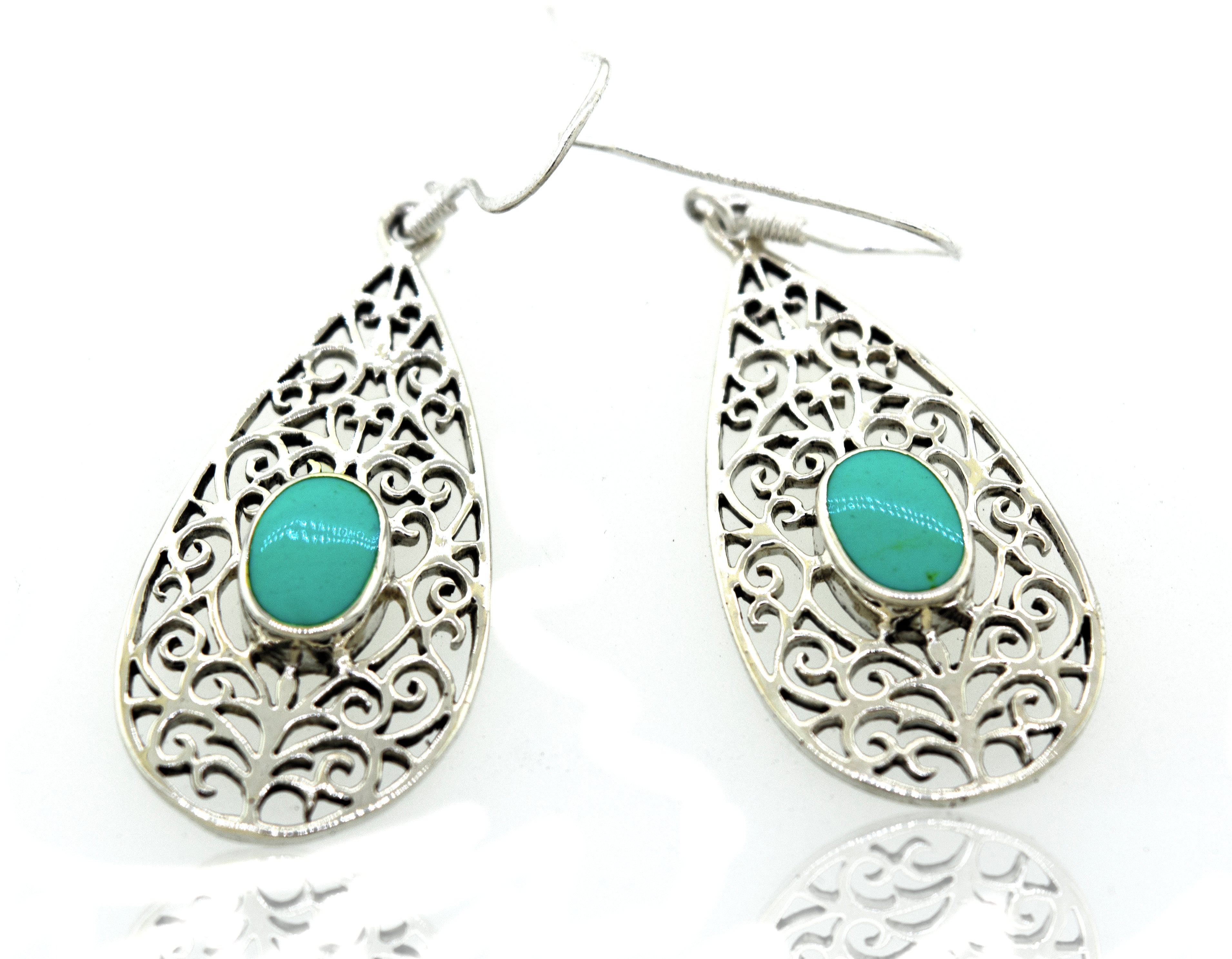 Super Silver presents the Elegant Teardrop Shape Turquoise Earrings featuring a teardrop-shaped turquoise stone and filigree design.