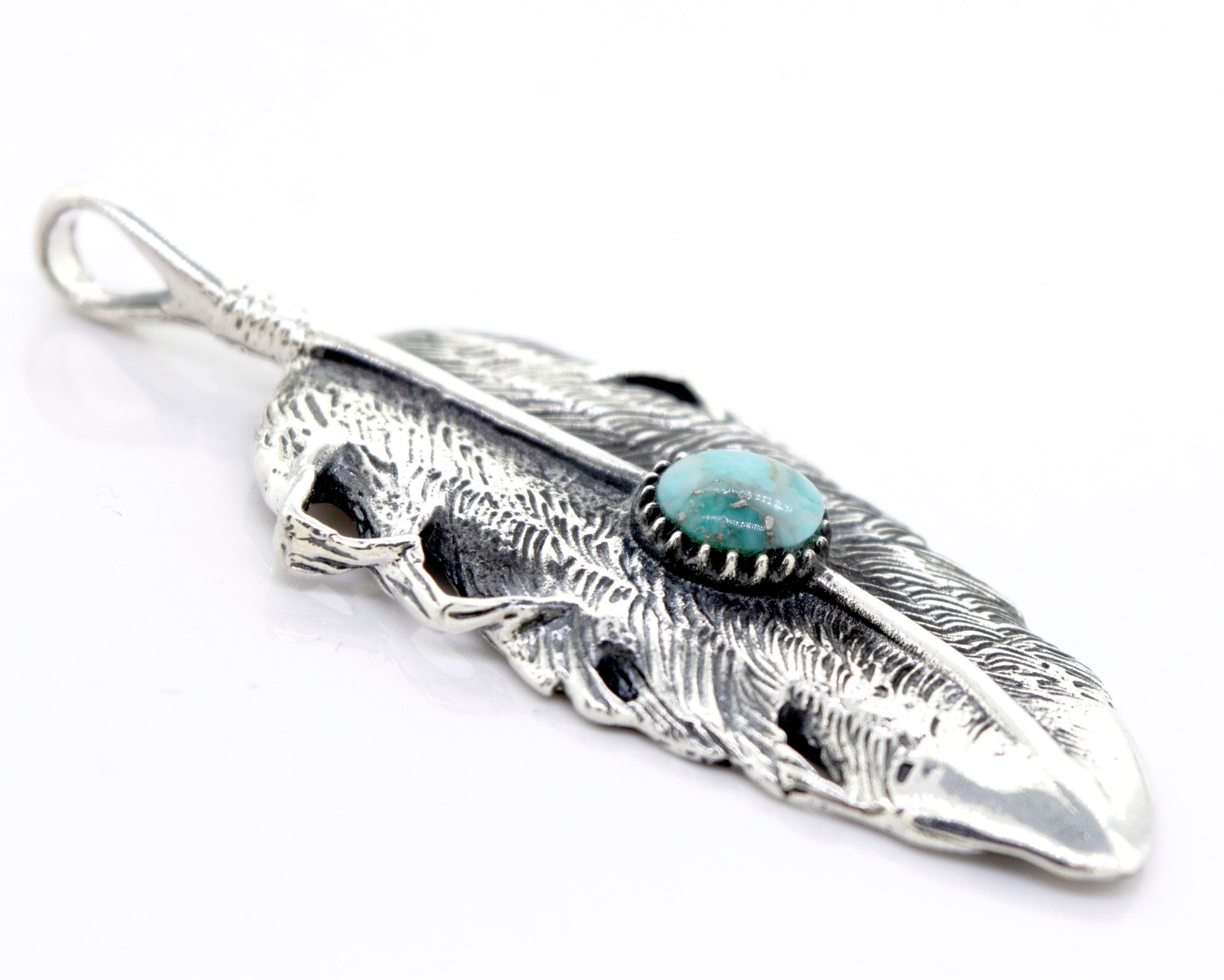 The Super Silver Native Inspired Feather Pendant With Turquoise adorns this sterling silver feather design pendant.