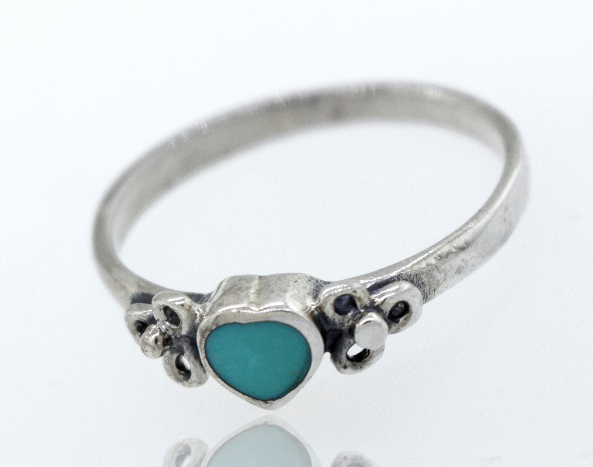 A sterling silver "Turquoise Heart Ring With Flower Designs" with a turquoise stone and a flower design.