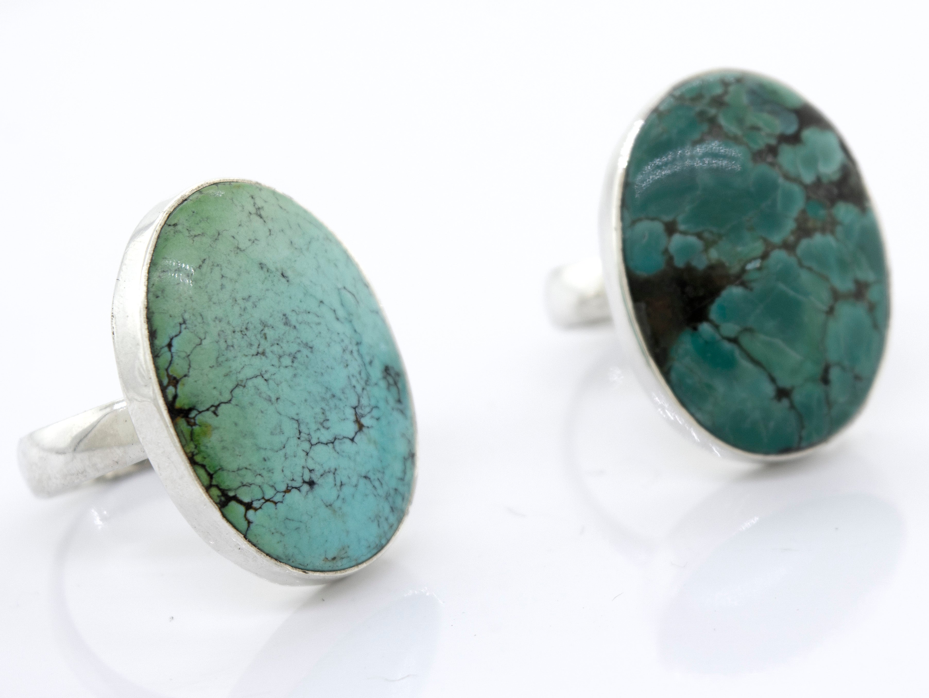 A pair of unique Oval Natural Turquoise Rings with a sterling silver setting, showcasing the natural beauty and vibrance of the turquoise stones. These rings are from Super Silver.