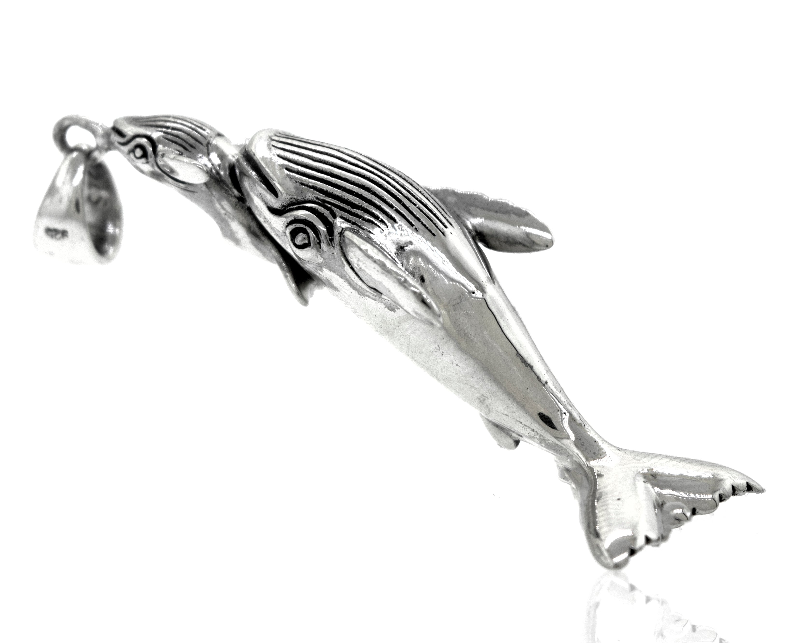 A Super Silver Handcrafted Whale And Calf Pendant on a white background.