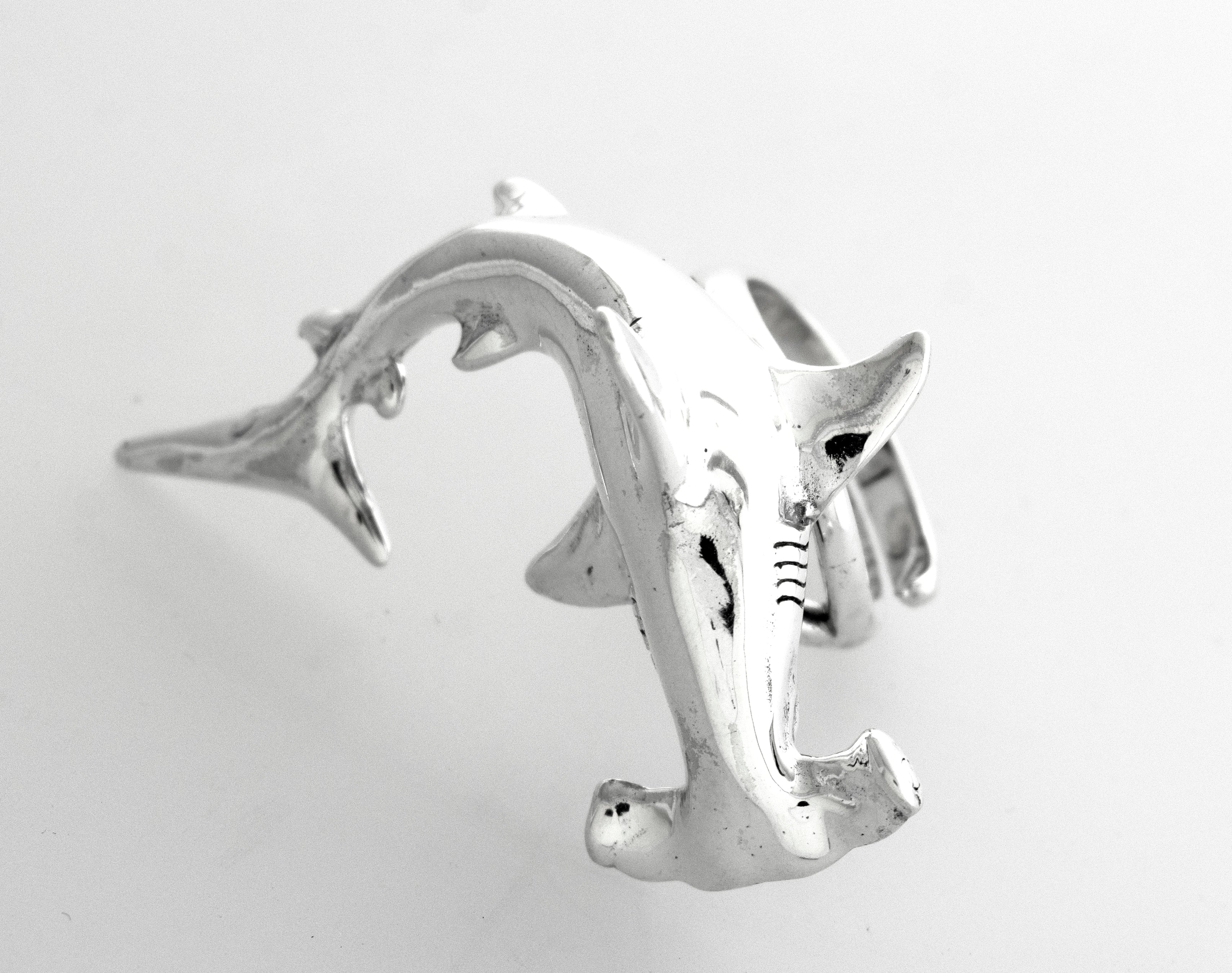 A sterling silver Hammerhead Shark Ring on a white surface.