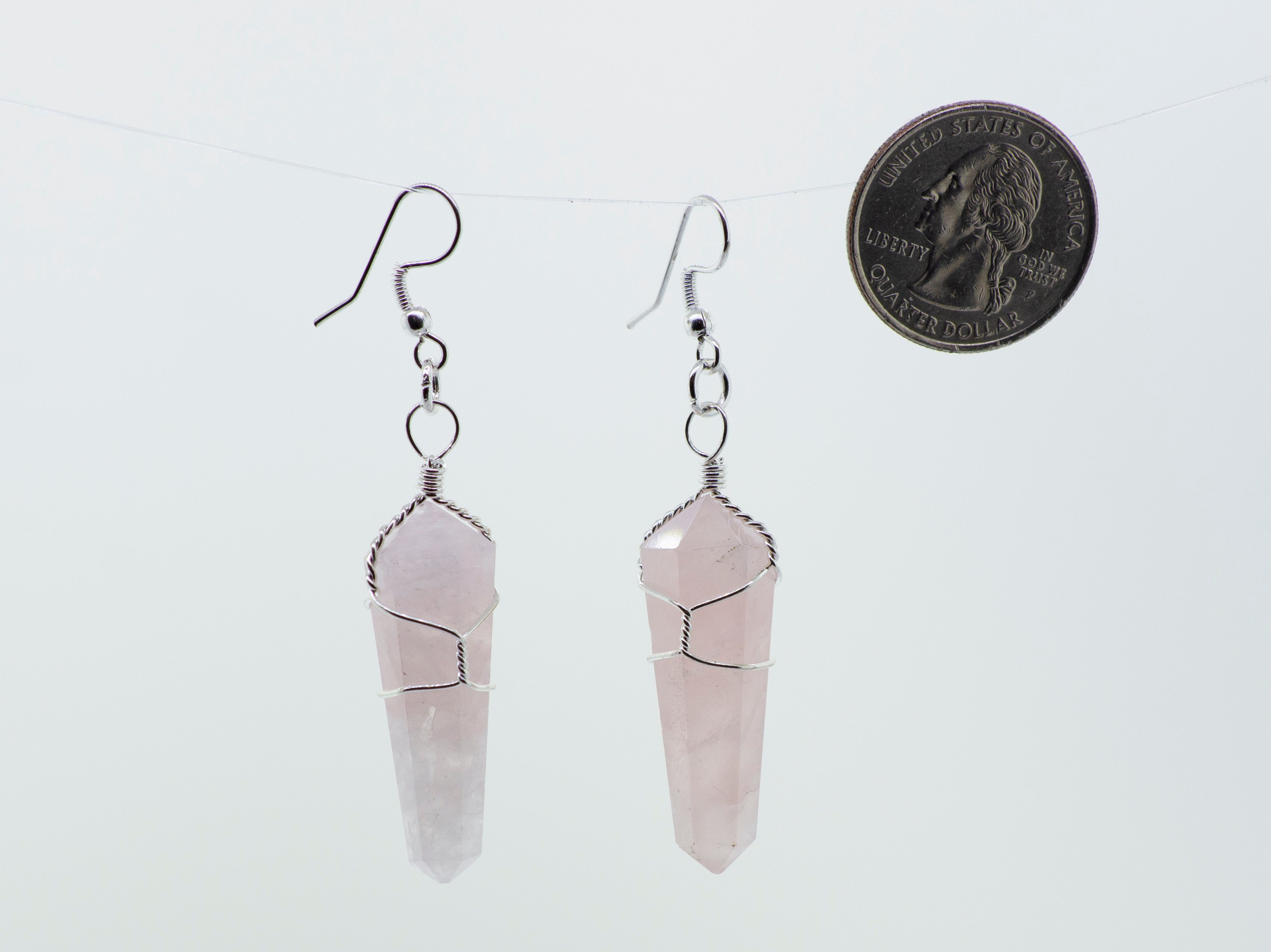 A pair of Super Silver Wire Wrapped Stone Earrings, perfect for everyday wear, hanging from a delicate chain.