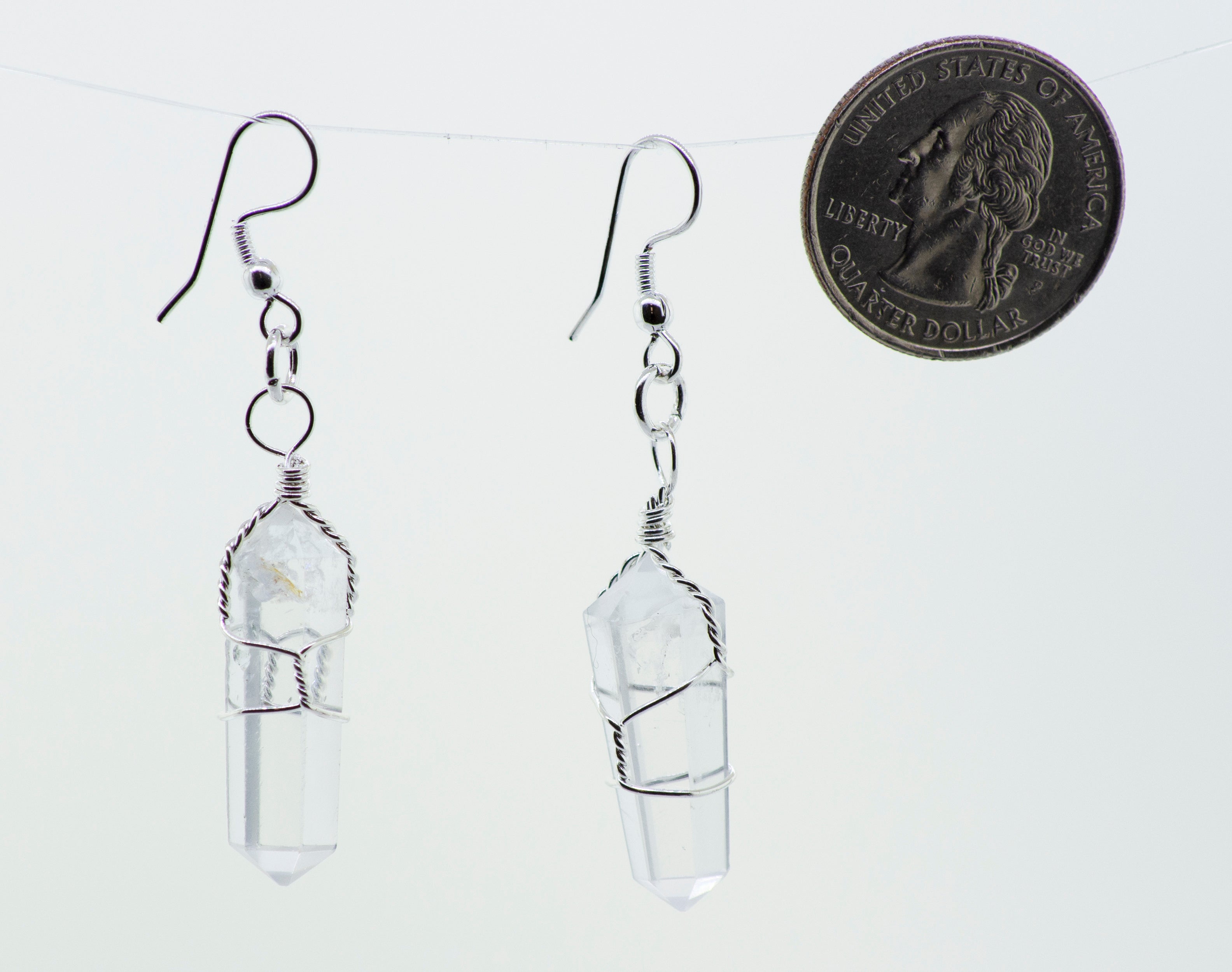 A pair of Super Silver Wire Wrapped Stone Earrings with a penny hanging from them made of mixed metal.