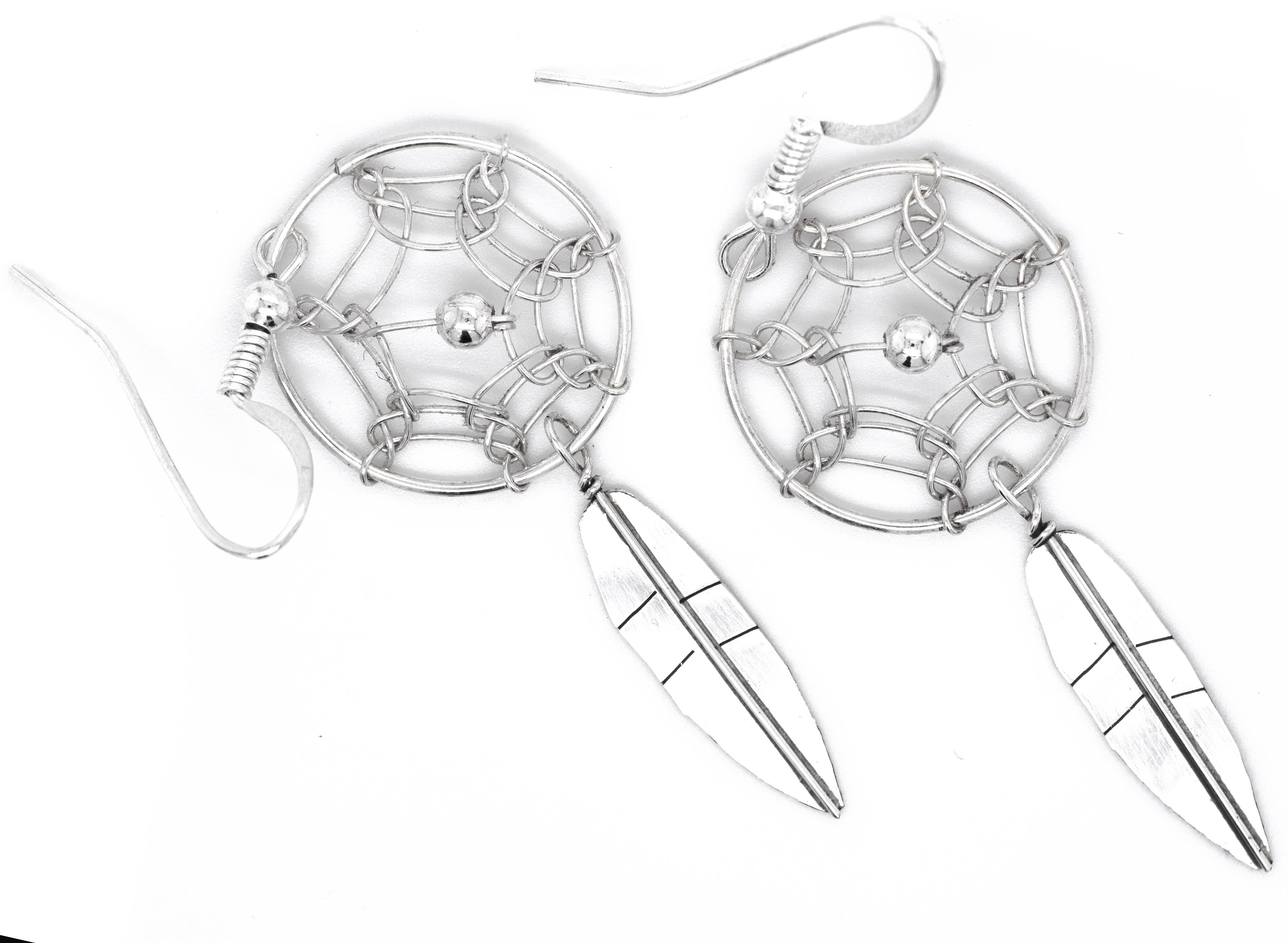 An authentic pair of Super Silver Zuni dreamcatcher earrings on a white background.
