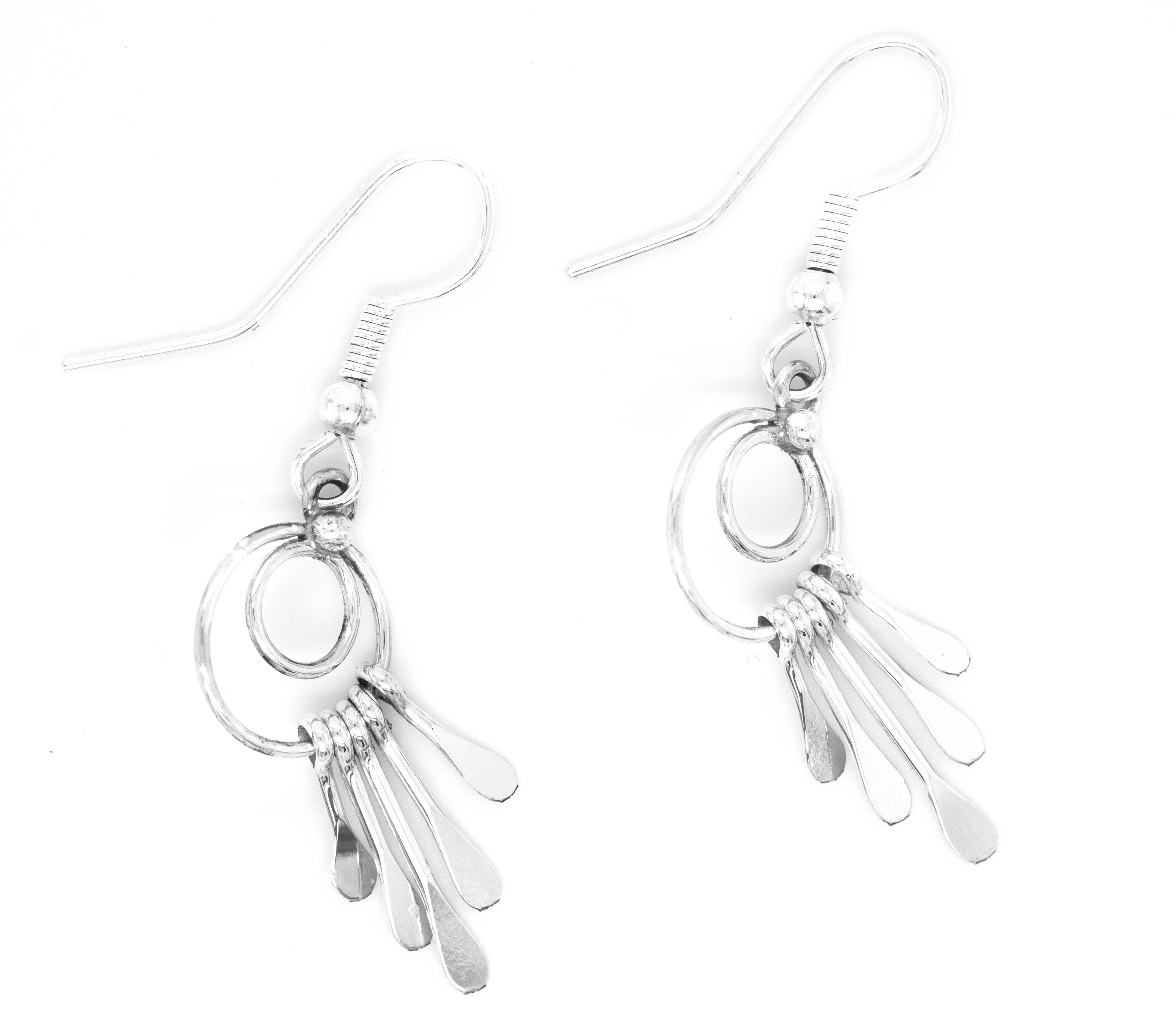 Handmade Zuni Silver Waterfall Earrings by Super Silver dangle gracefully on a white background.
