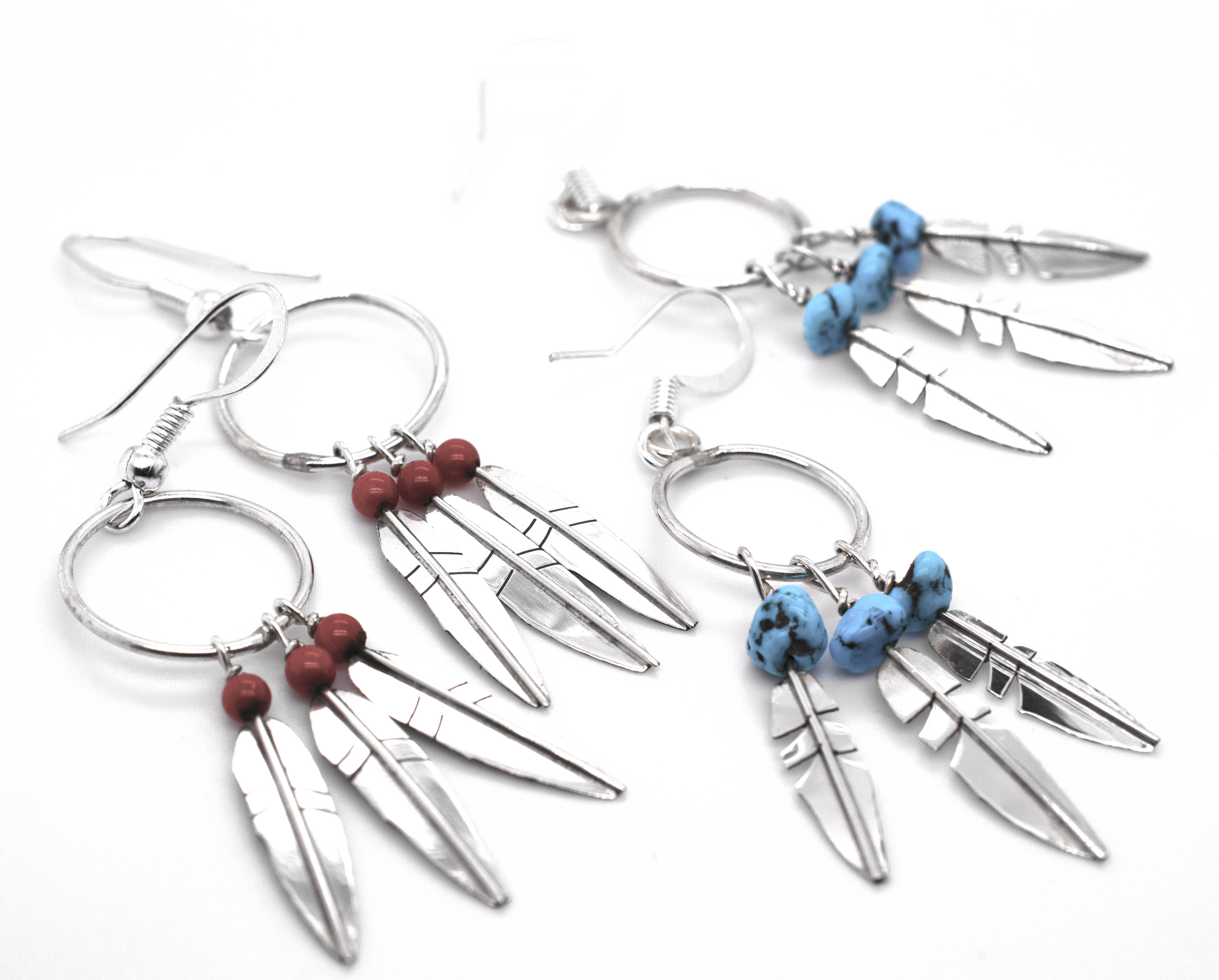 A pair of Super Silver Enchanting Zuni Feather Earrings with Coral or Turquoise Beads.