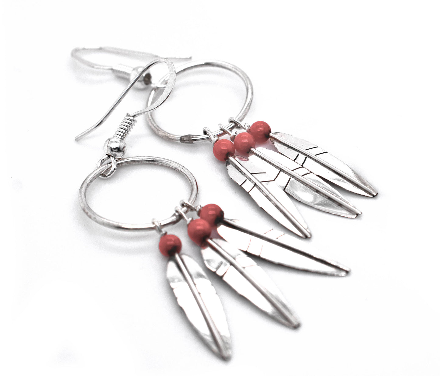 A pair of Enchanting Zuni Feather Earrings with Coral Or Turquoise Beads by Super Silver, perfect for adding a touch of southwest flair to any outfit.
