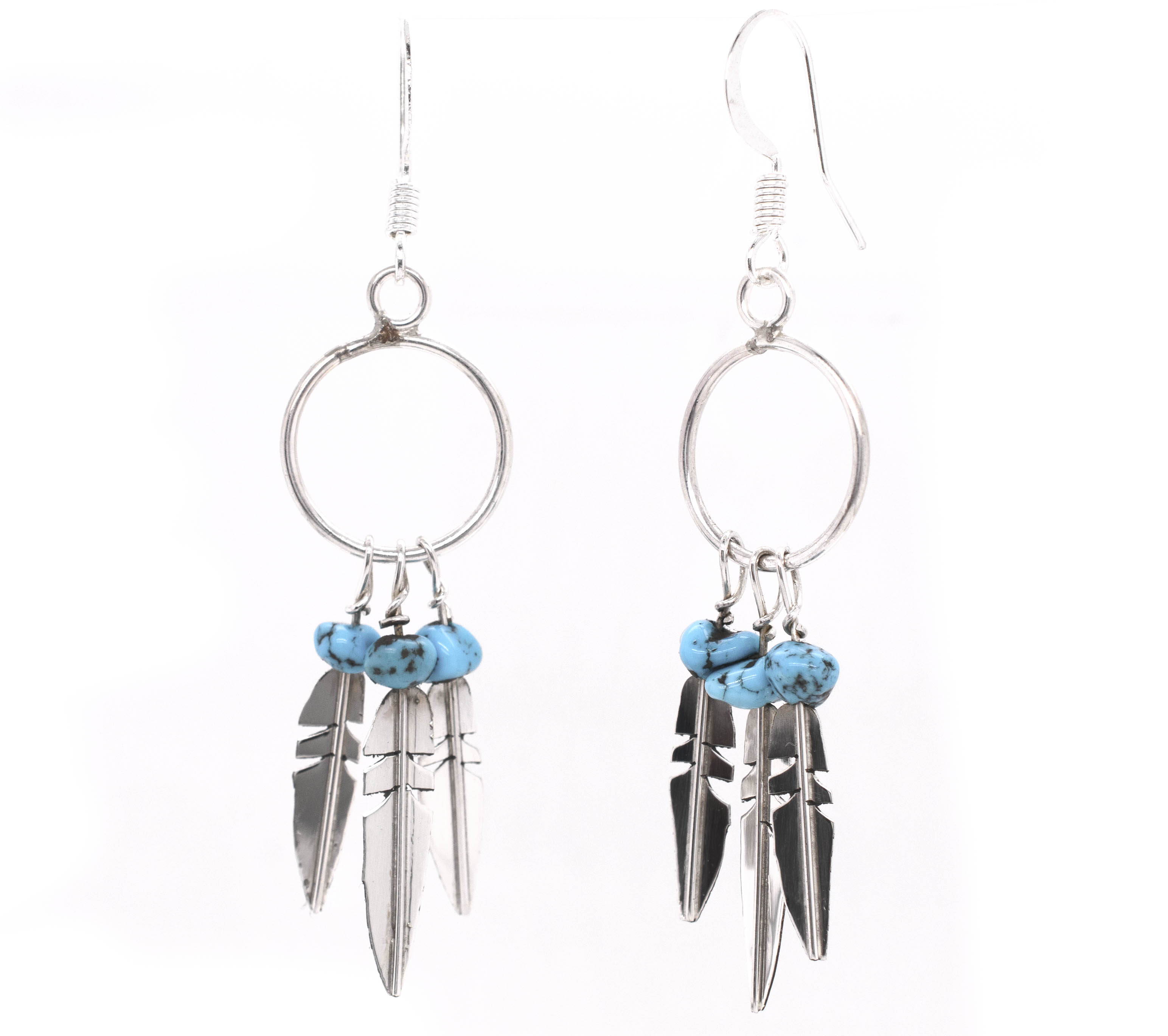A pair of silver earrings with Enchanting Zuni Feather Earrings With Coral Or Turquoise Beads and feathers from Super Silver.