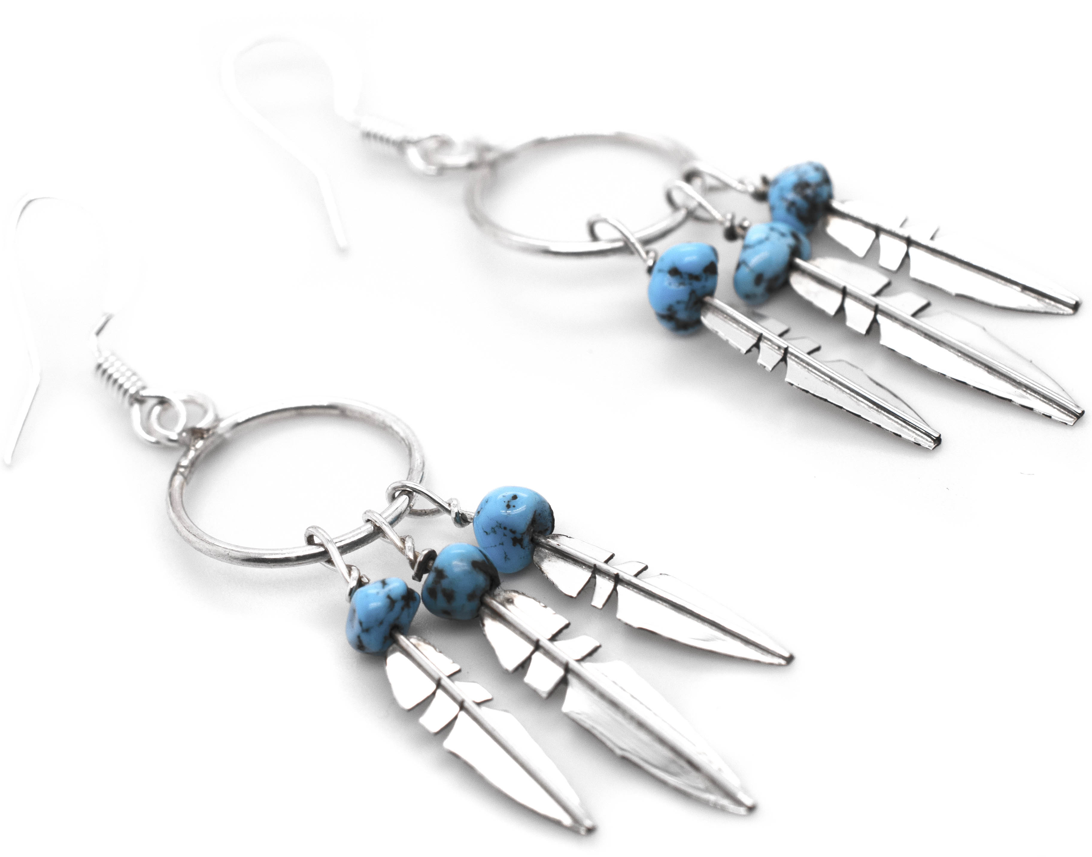 A pair of Enchanting Zuni Feather Earrings with Coral Or Turquoise Beads and a southwest-inspired design by Super Silver.