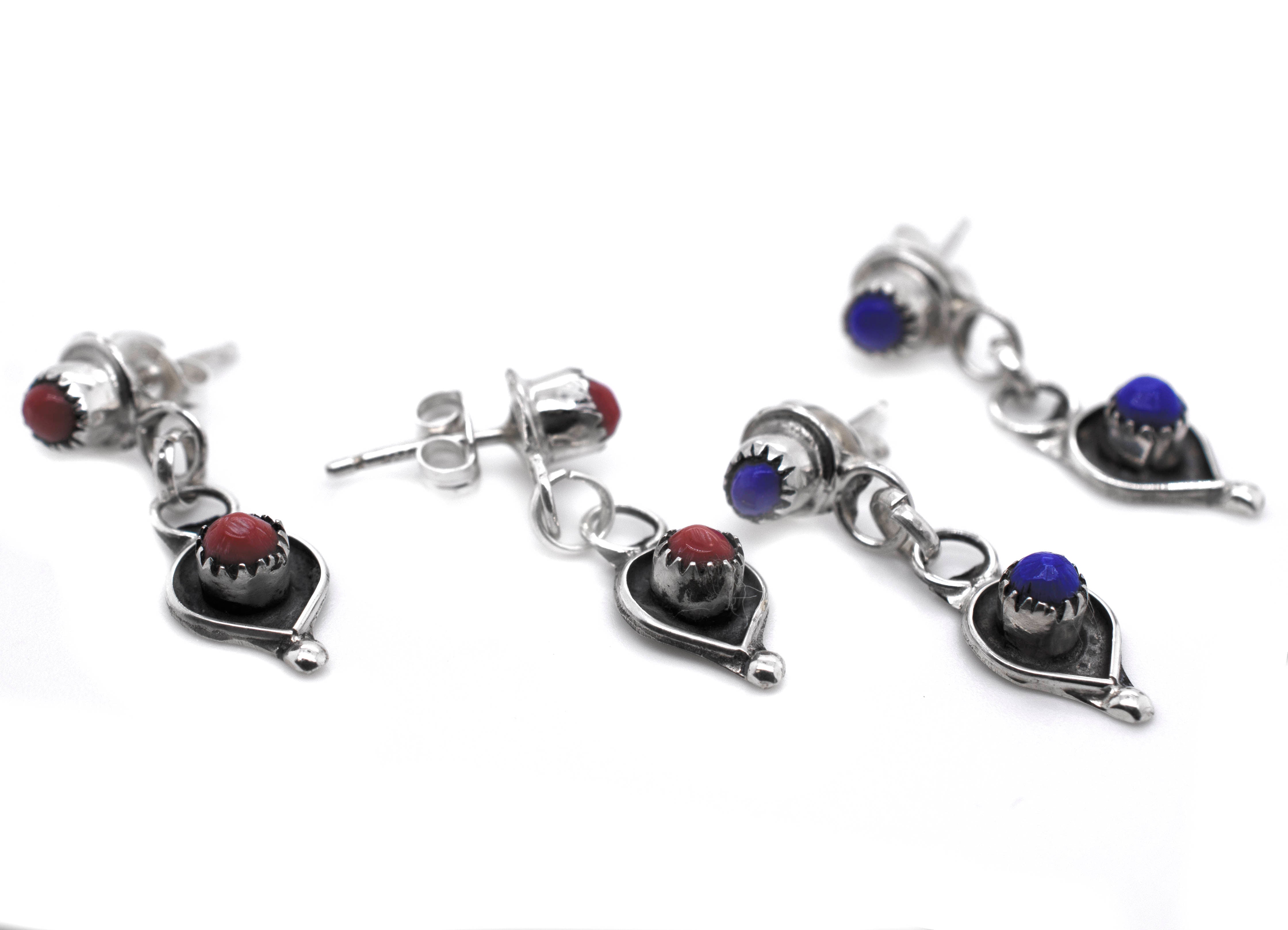 A pair of Delicate Zuni Lapis And Coral Earrings handmade by Super Silver with .925 Sterling Silver and adorned with blue and red stones.