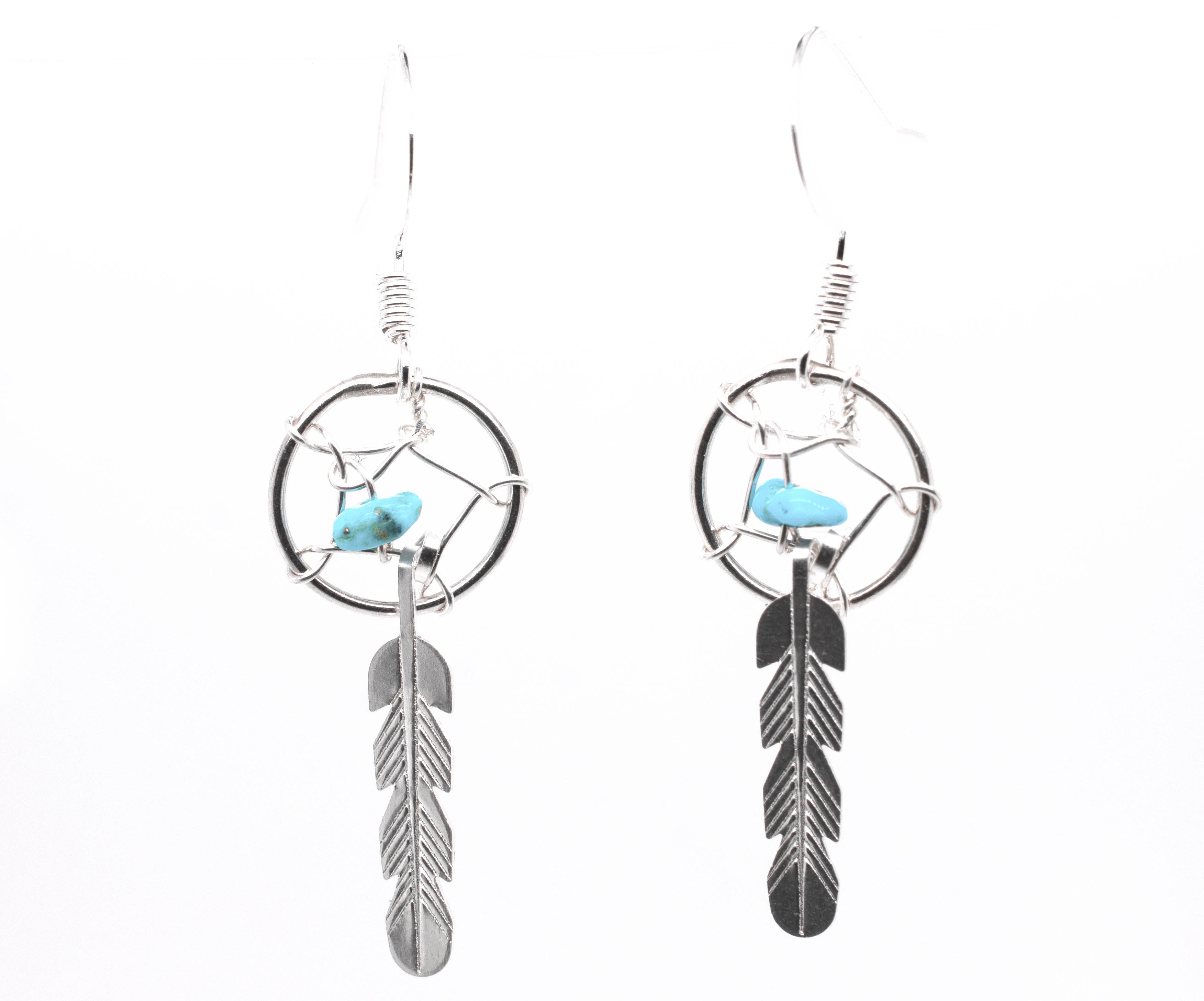 A pair of Super Silver Zuni Turquoise Dreamcatcher Earrings, inspired by Native American Zuni dreamcatchers and adorned with turquoise chip beads.