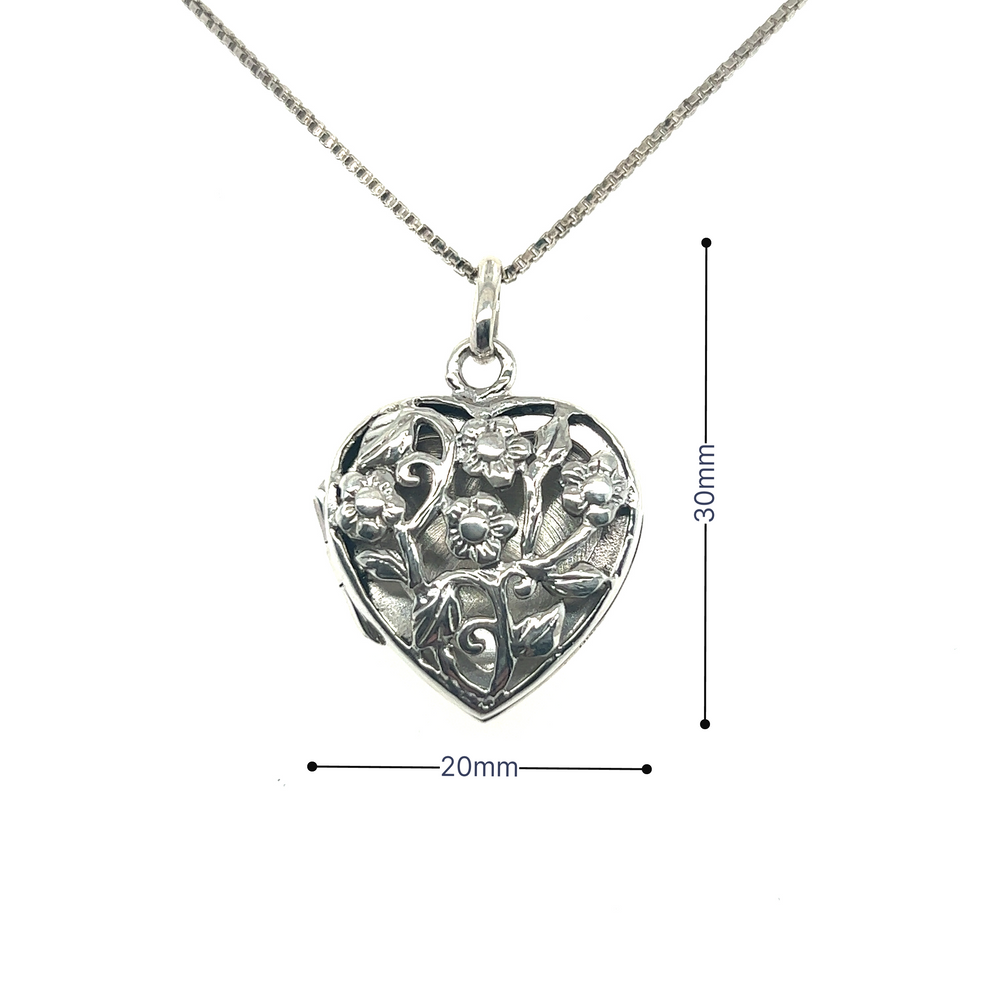 
                  
                    A Super Silver Floral Heart Shaped Locket pendant is shown on a silver chain.
                  
                