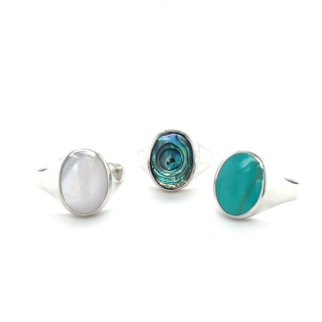 
                  
                    Three Sleek Oval Inlaid Stone Signet Rings with turquoise stones.
                  
                