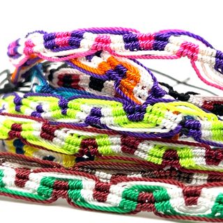 
                  
                    A pile of Super Silver Colorful Friendship Bracelets in bright and colorful designs, perfect for everyday style, placed on a white background.
                  
                