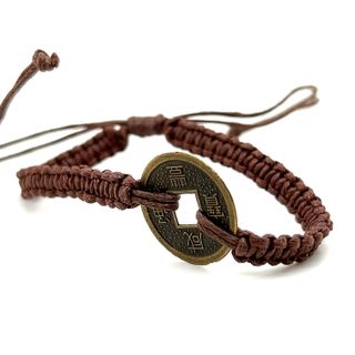 
                  
                    An adjustable Knotted Coin Bracelet with a woven coin by Super Silver.
                  
                