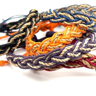 
                  
                    A Super Silver array of adjustable Colorful Braided Bracelets on a white background.
                  
                